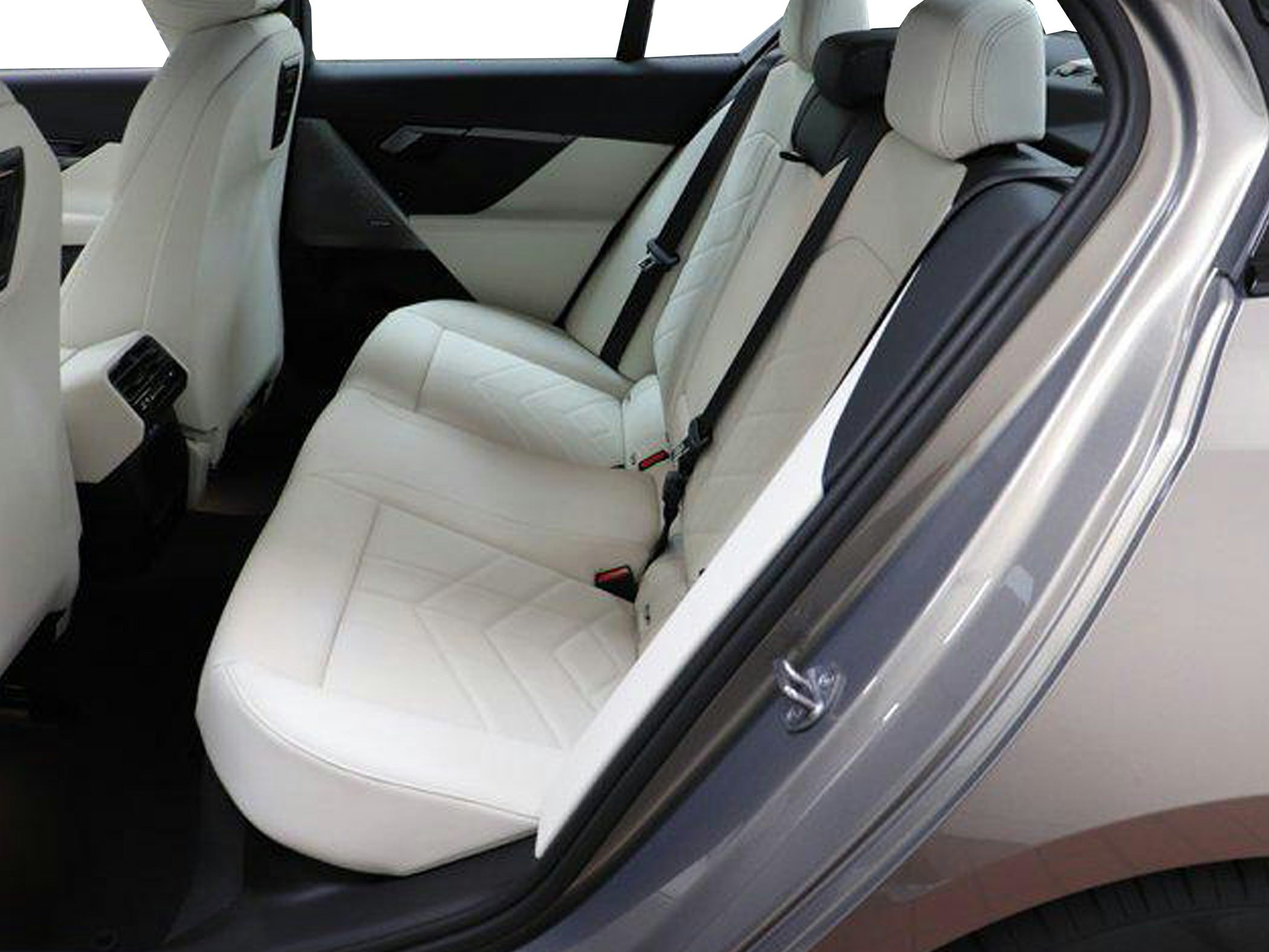 Luxurious white rear passenger seats with detailed stitching