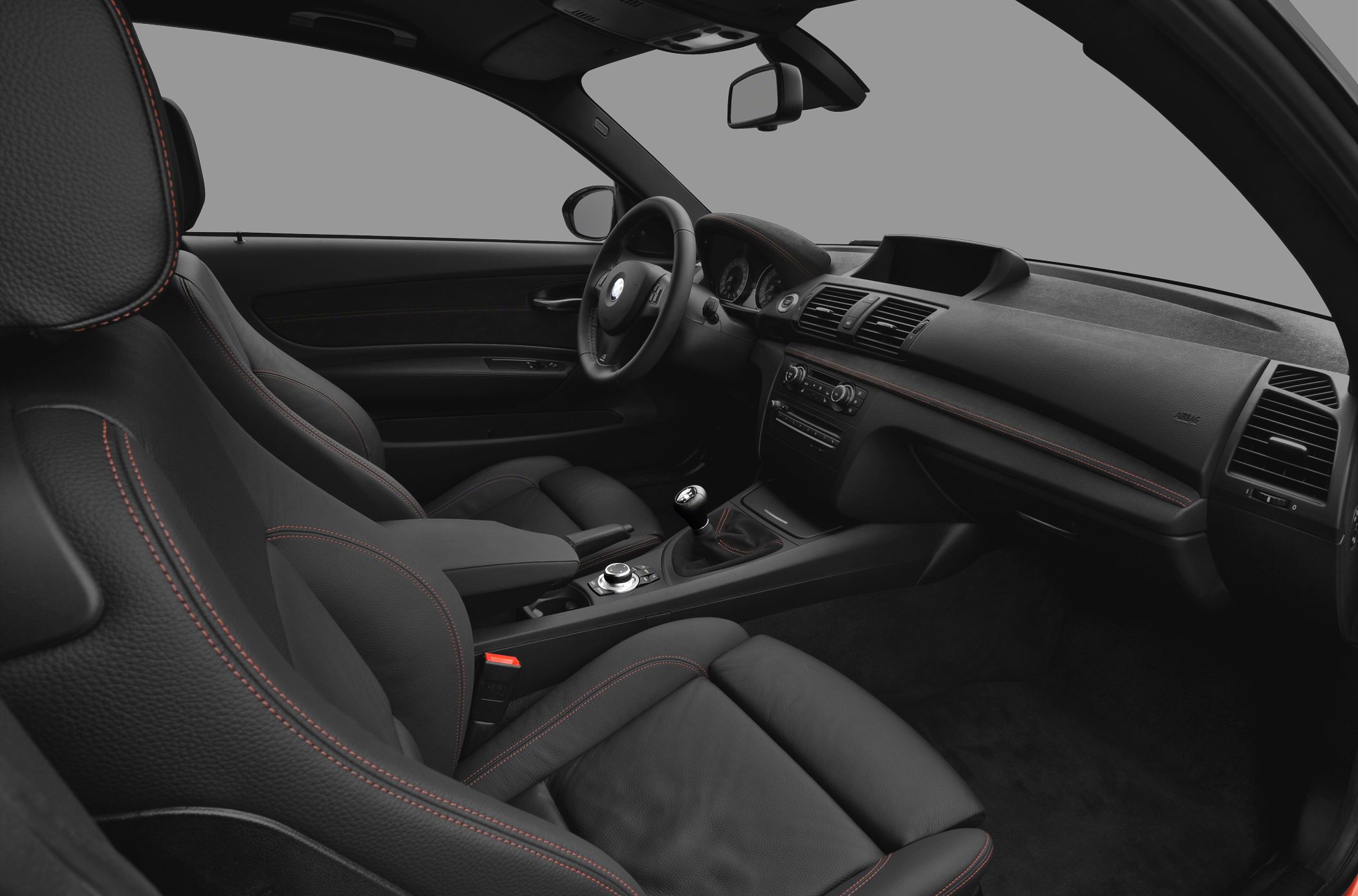 Black leather seats with red stitching and manual transmission interior