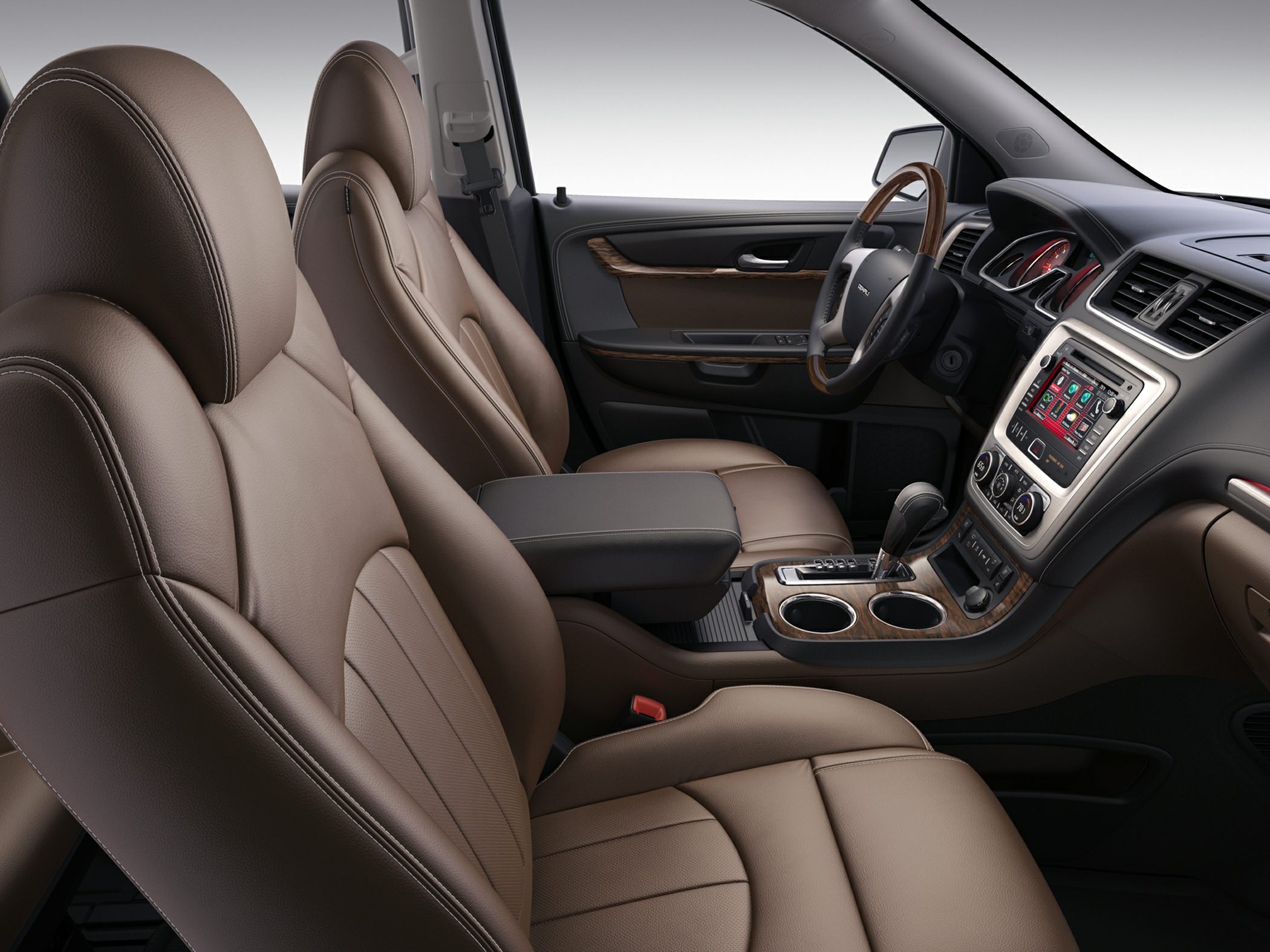 Brown leather seats with wood trim and touchscreen infotainment system