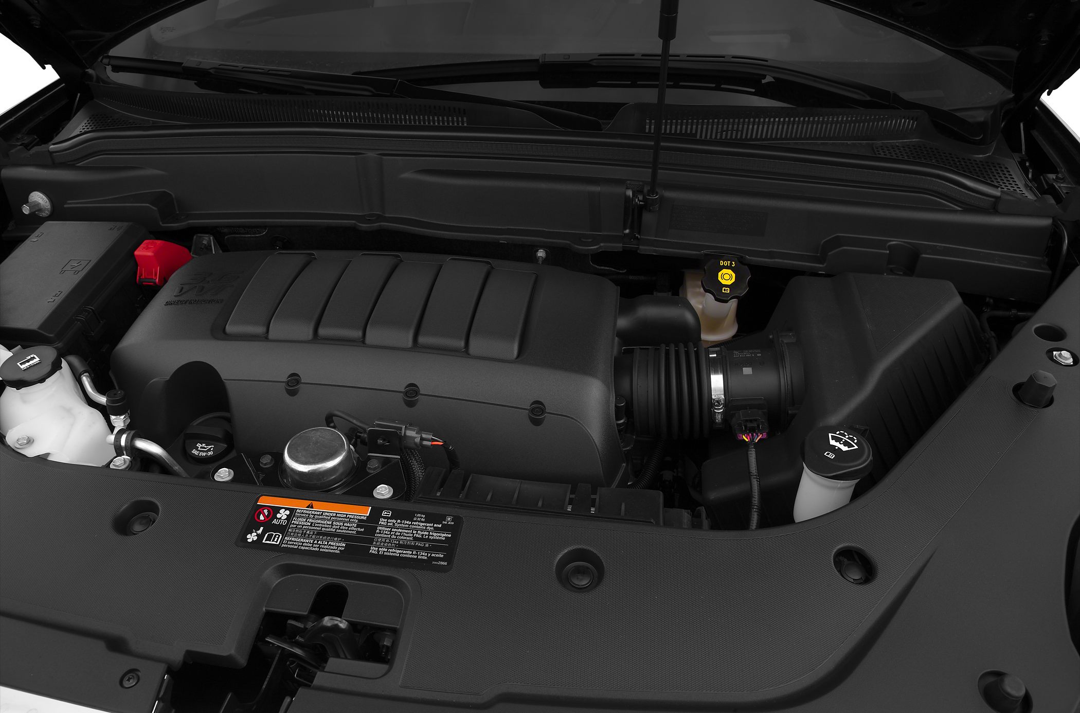 Engine bay with cover, air intake hose, and fluid reservoirs