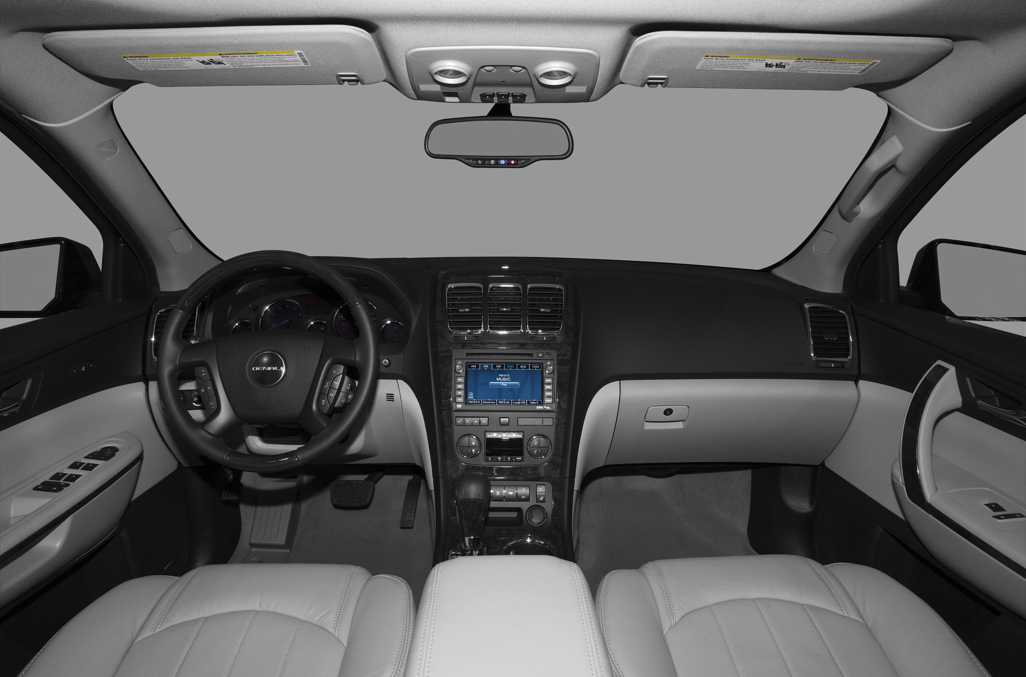 Dashboard, steering wheel, center console, and front seats of a car interior