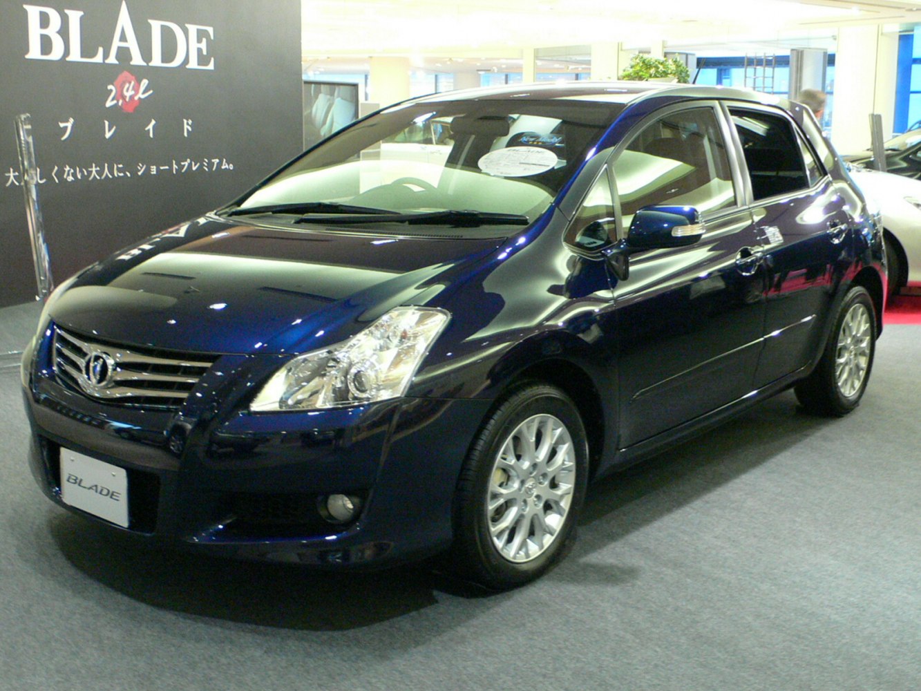 Front side view of hatchback with alloy wheels indoors