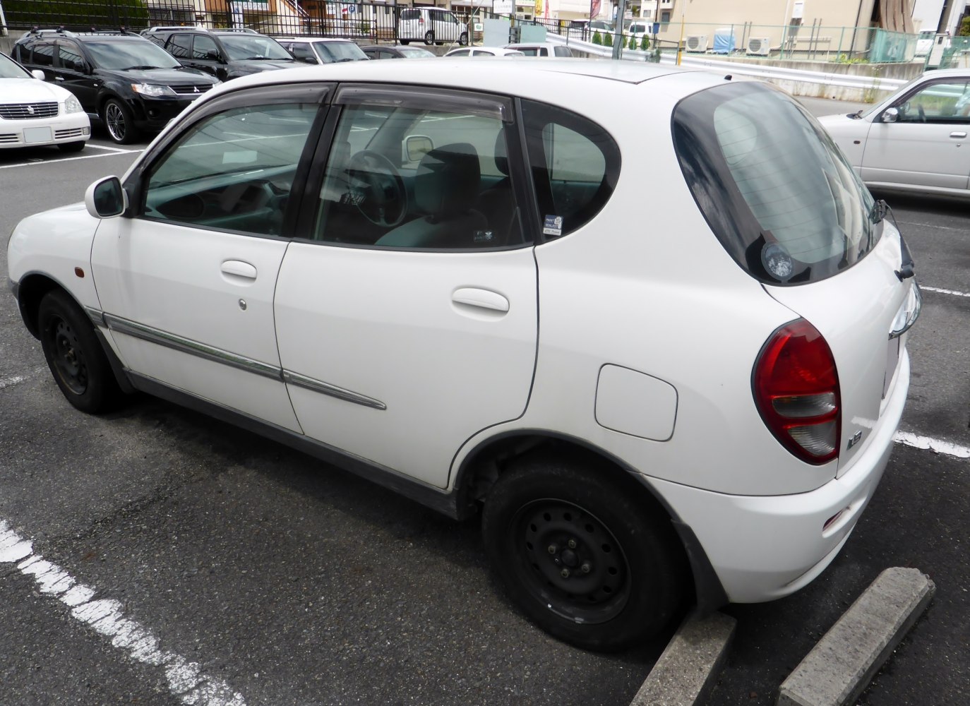 Compact 5-door hatchback with rounded rear windows and steel wheels