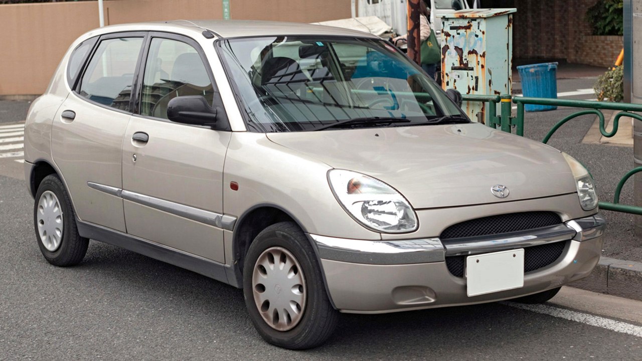 Small hatchback with rounded headlights and chrome front bumper