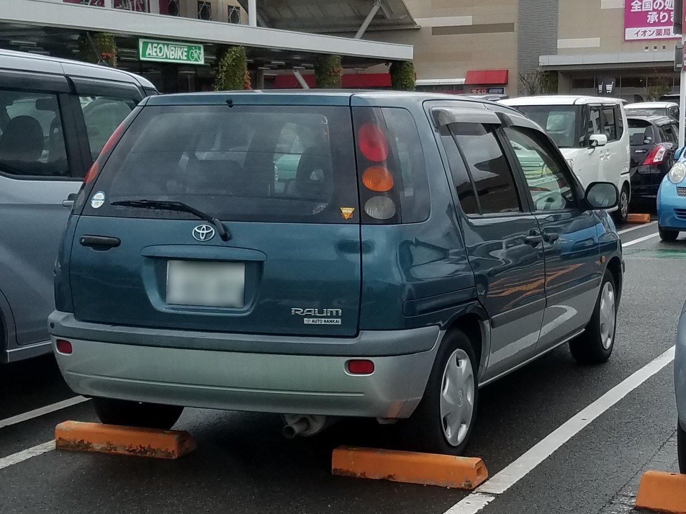 Rear view with vertical taillights and compact hatchback design