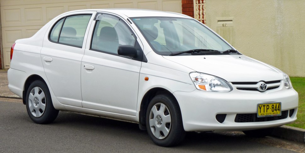 Compact sedan with rounded headlights and smooth body lines in front-side view.