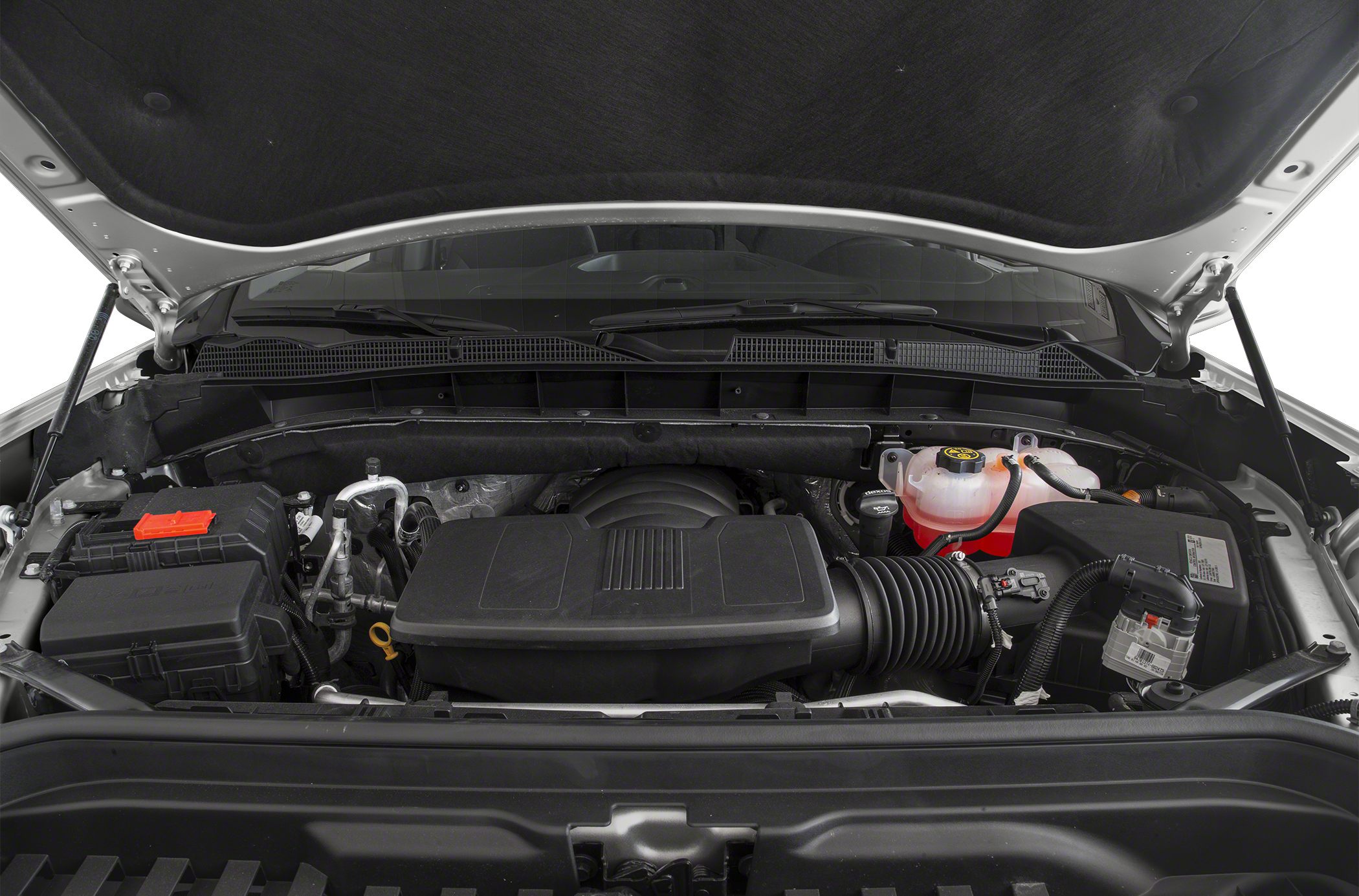 Engine bay with air intake system and coolant reservoir