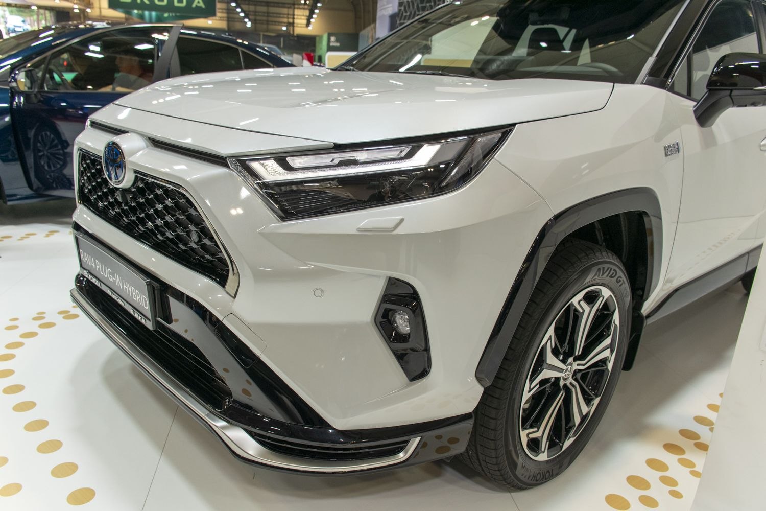 Front LED headlights and black grille of modern SUV