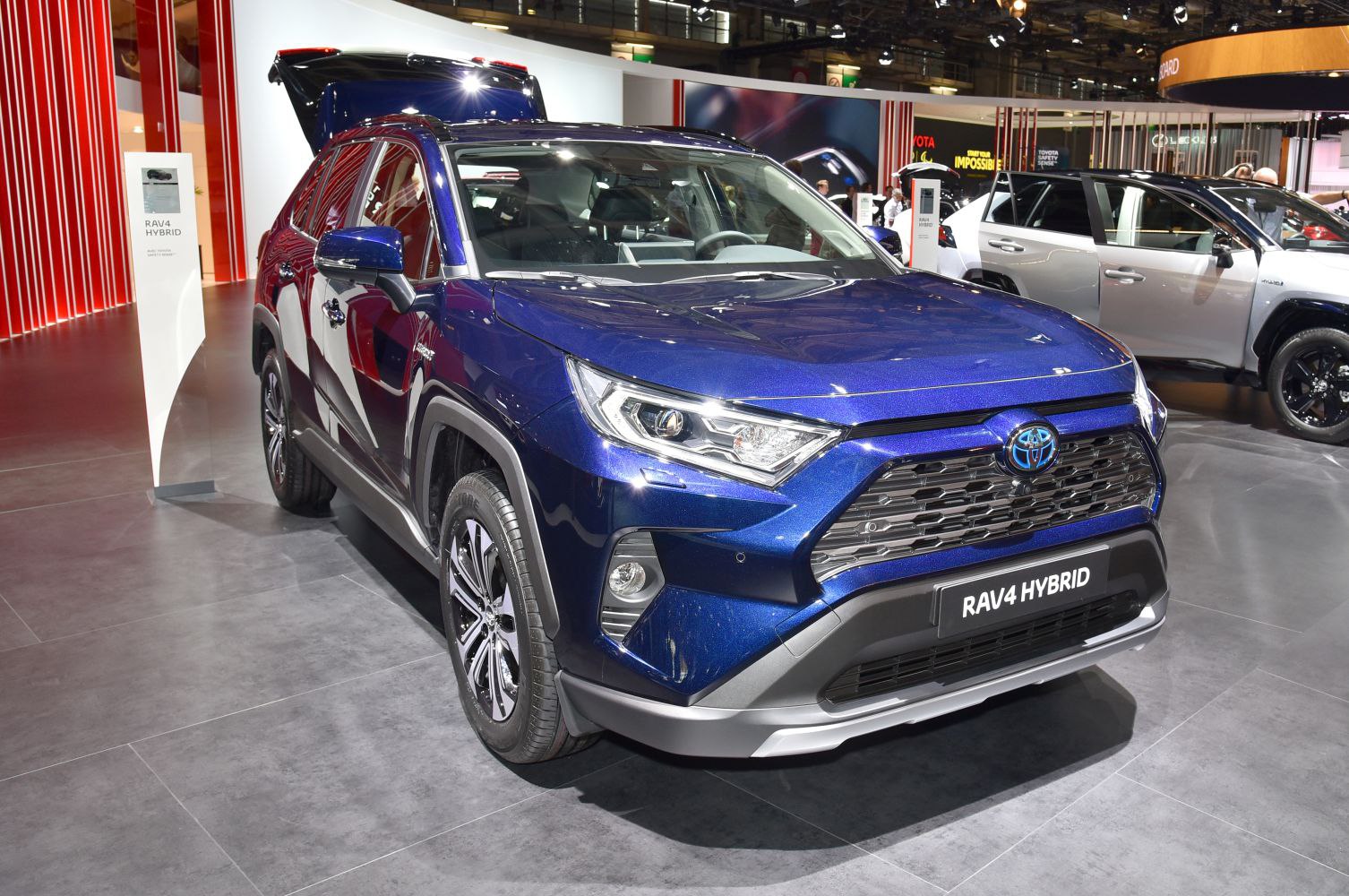 Blue hybrid SUV with bold grille and sharp LED headlights