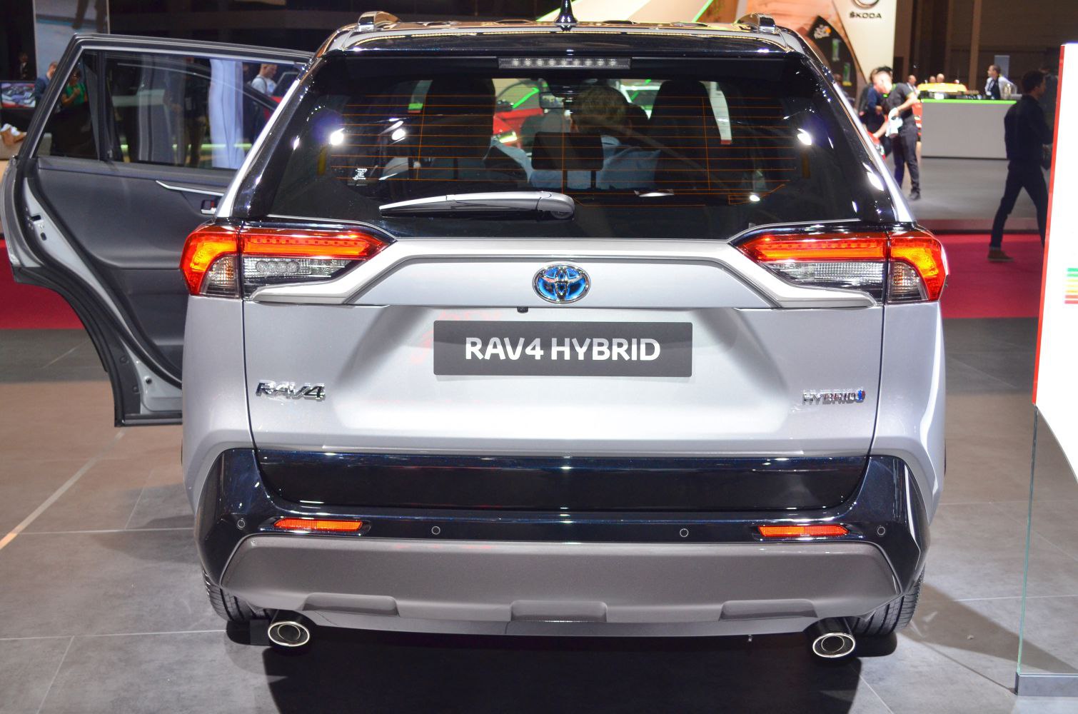 Rear view of hybrid SUV with dual exhaust, tail lights, and rear window wiper