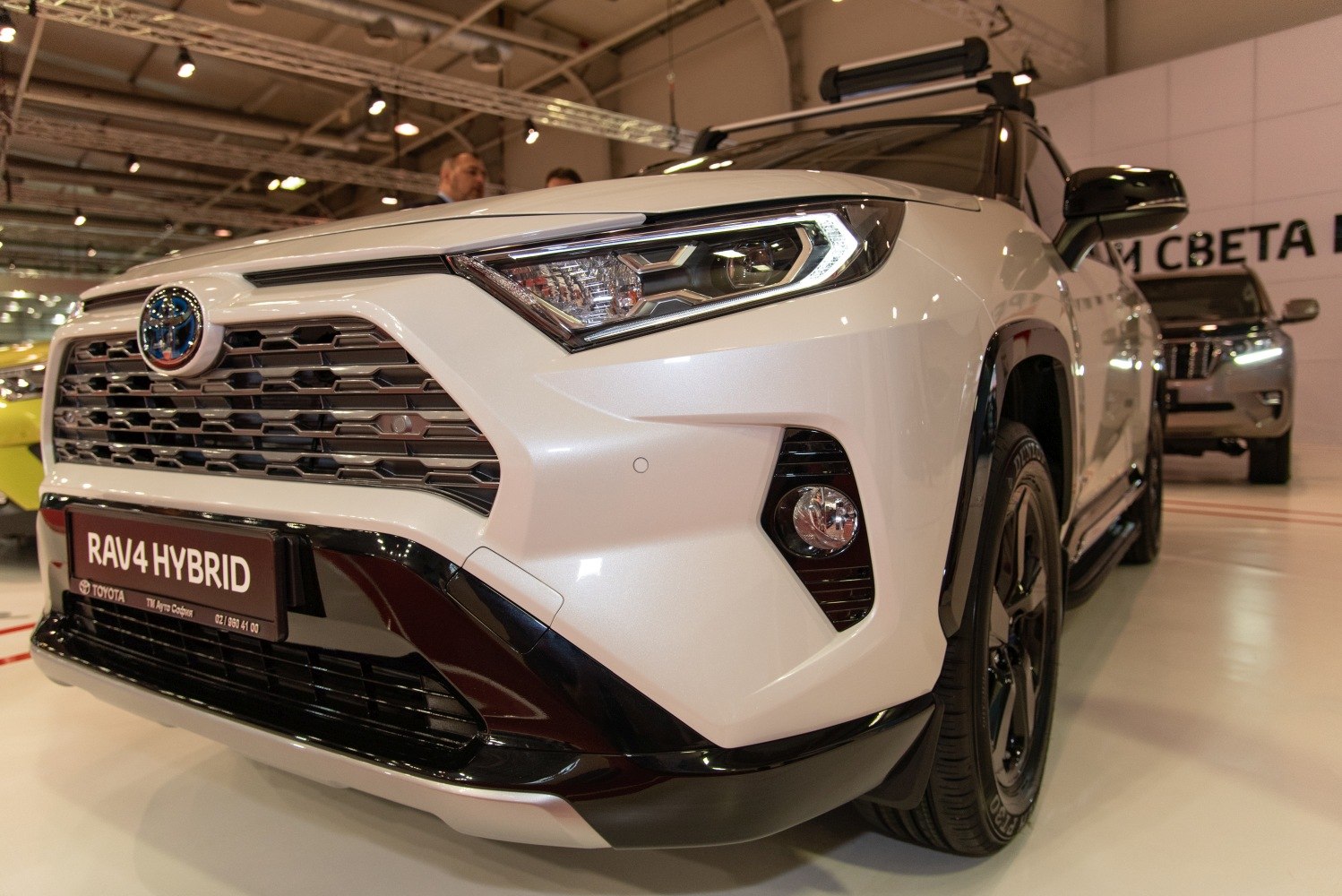 Close-up of front end with LED headlights and hybrid badge