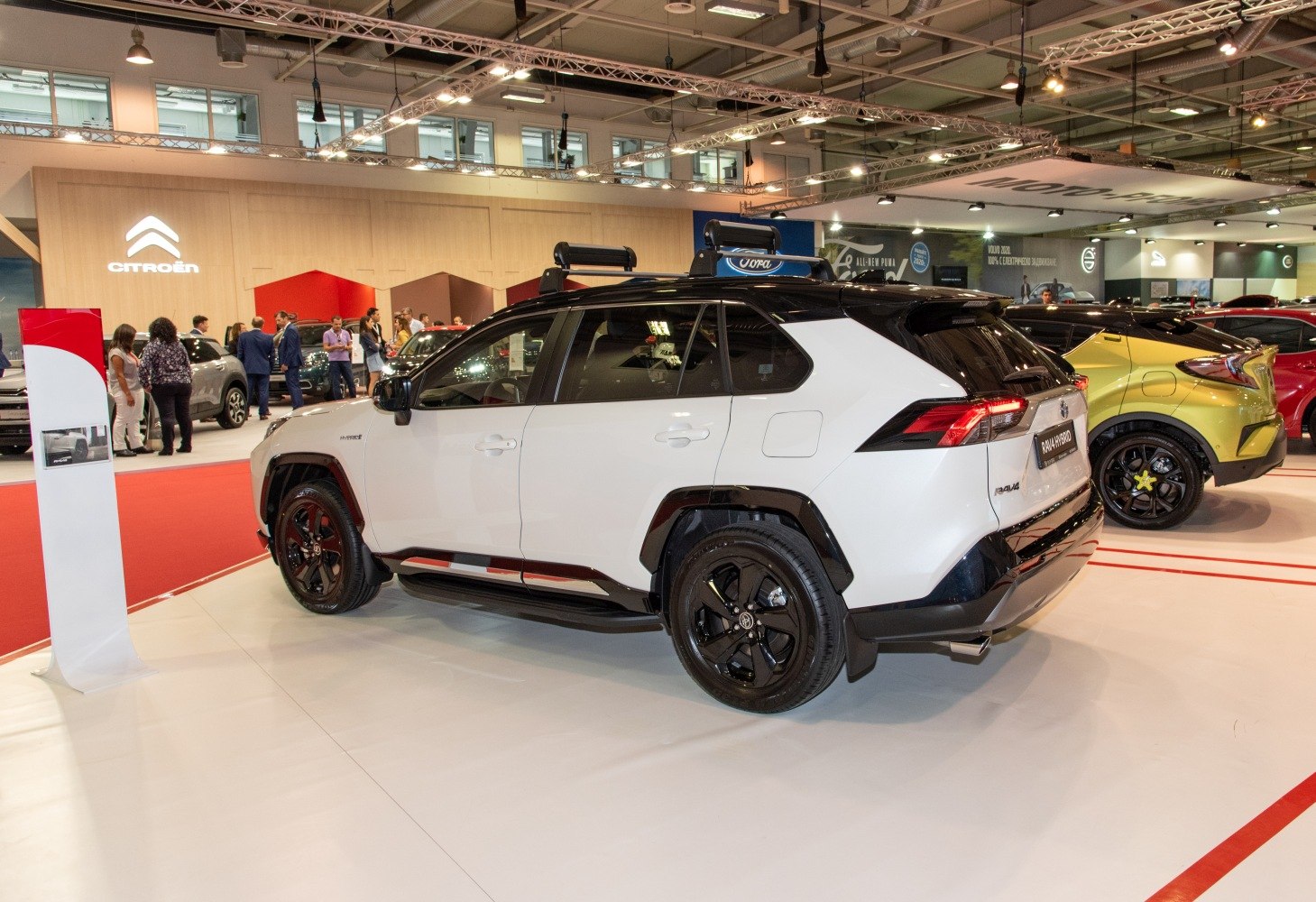 Side and rear view of SUV with roof rack and two-tone paint