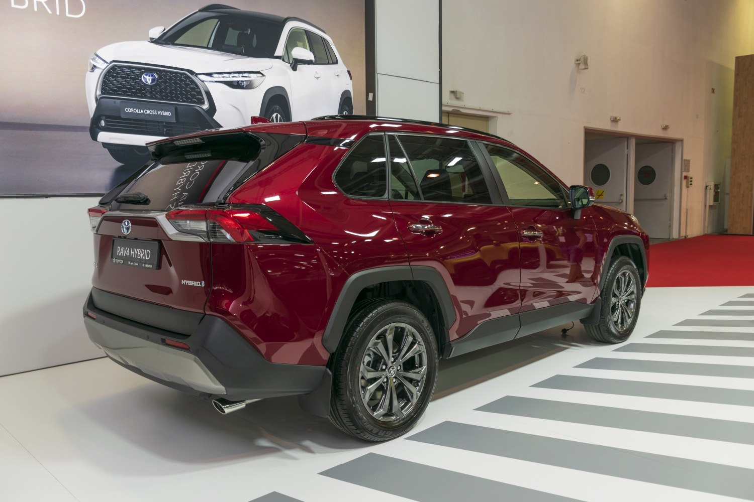 Rear side hybrid SUV with angular tail lights and multi-spoke alloy wheels