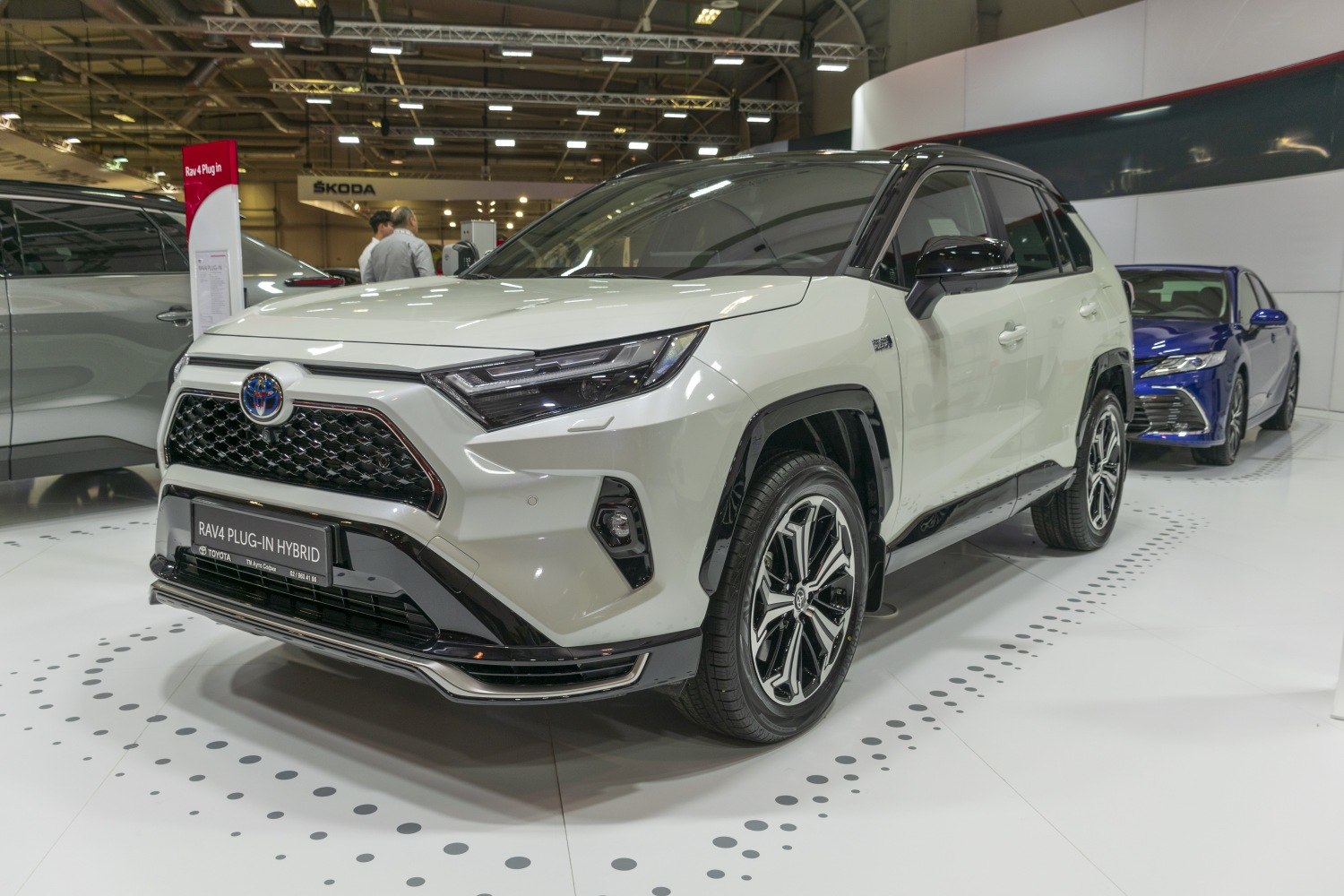 Front and side view of a Plug-In Hybrid SUV with LED headlights and distinctive grille.