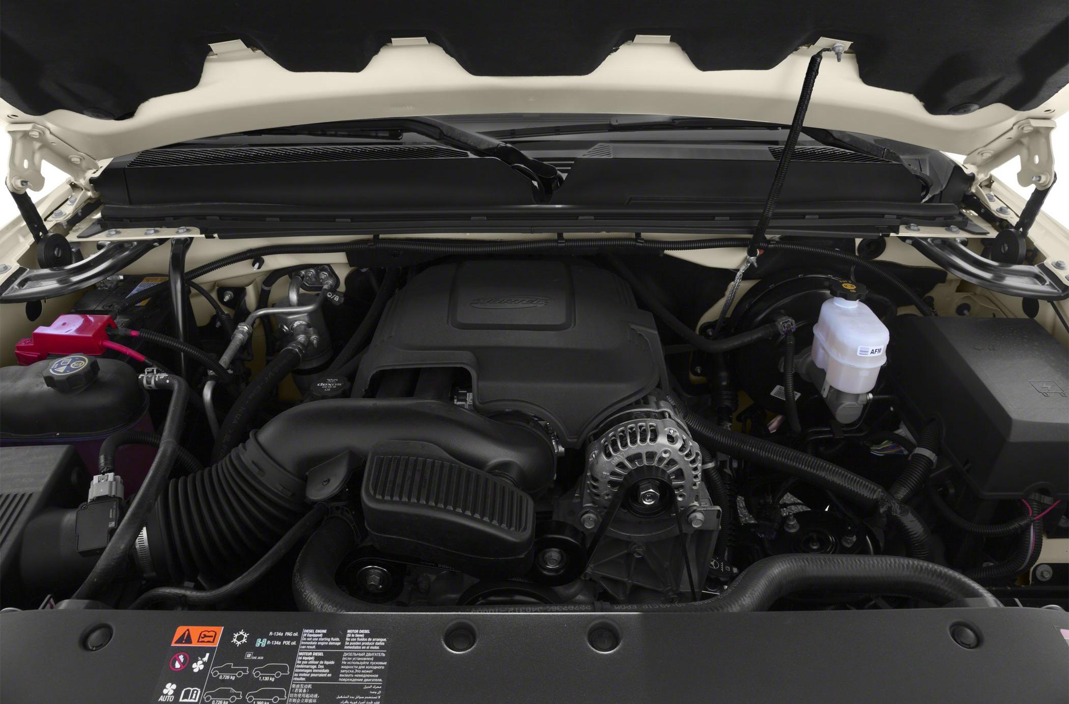 Detailed engine bay with hoses, alternator, air intake, and fluid reservoirs