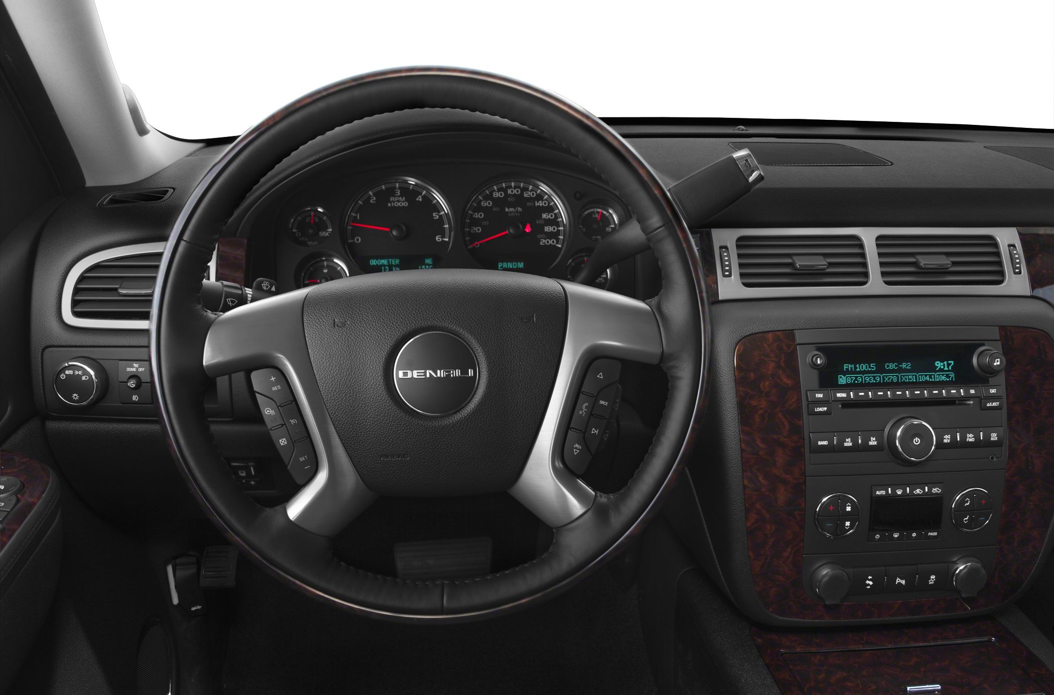 Steering wheel and dashboard with controls and wood trim