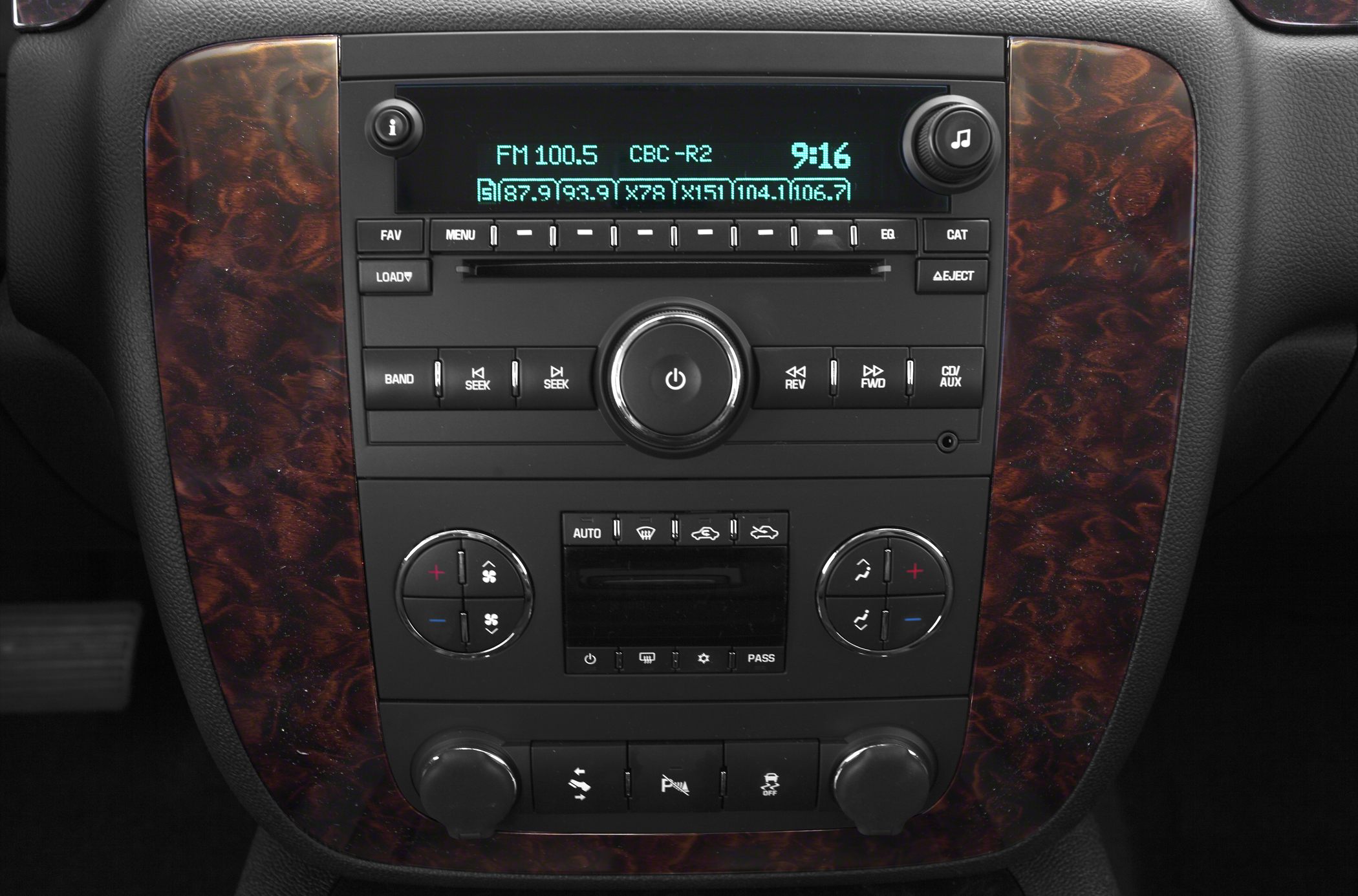Radio and media controls with dual-zone climate control and wood trim