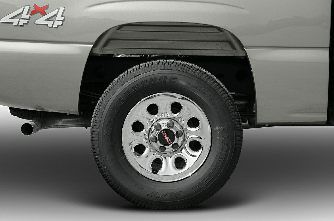 Rear chrome wheel with Bridgestone tire and visible exhaust pipe