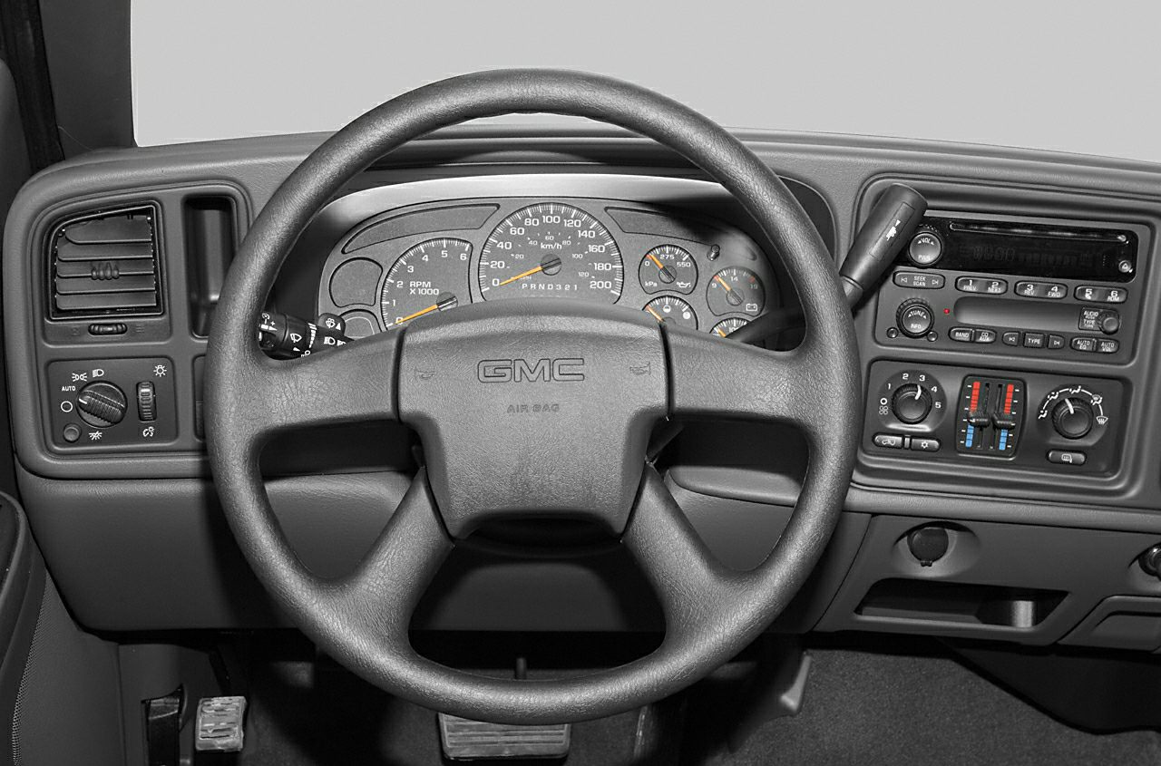 Close-up of dashboard and steering wheel with instruments and controls
