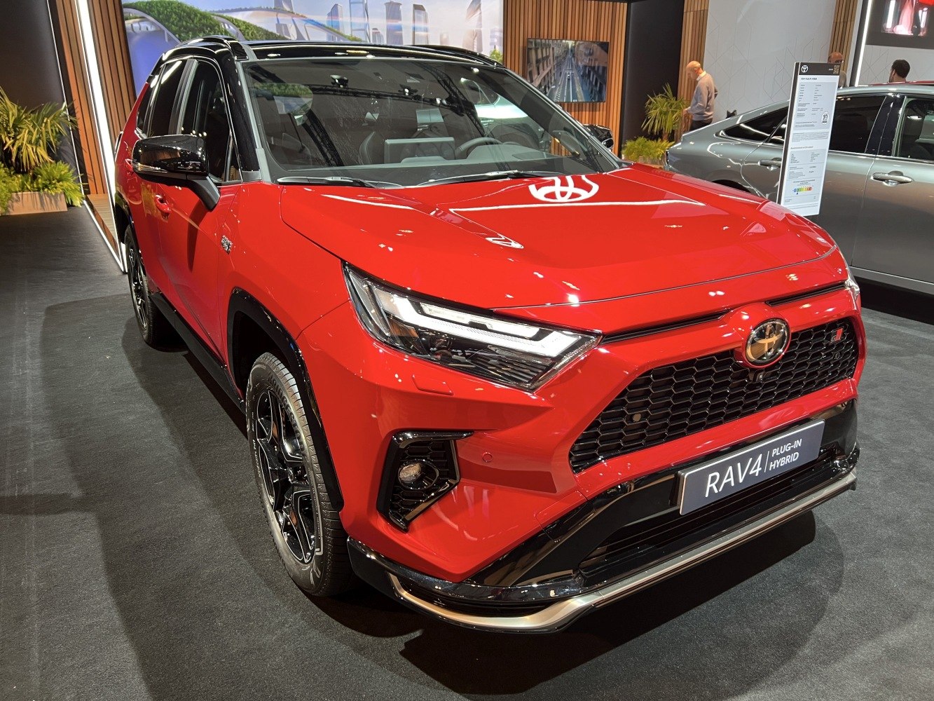 Front view of red plug-in hybrid SUV with LED headlights and black trim