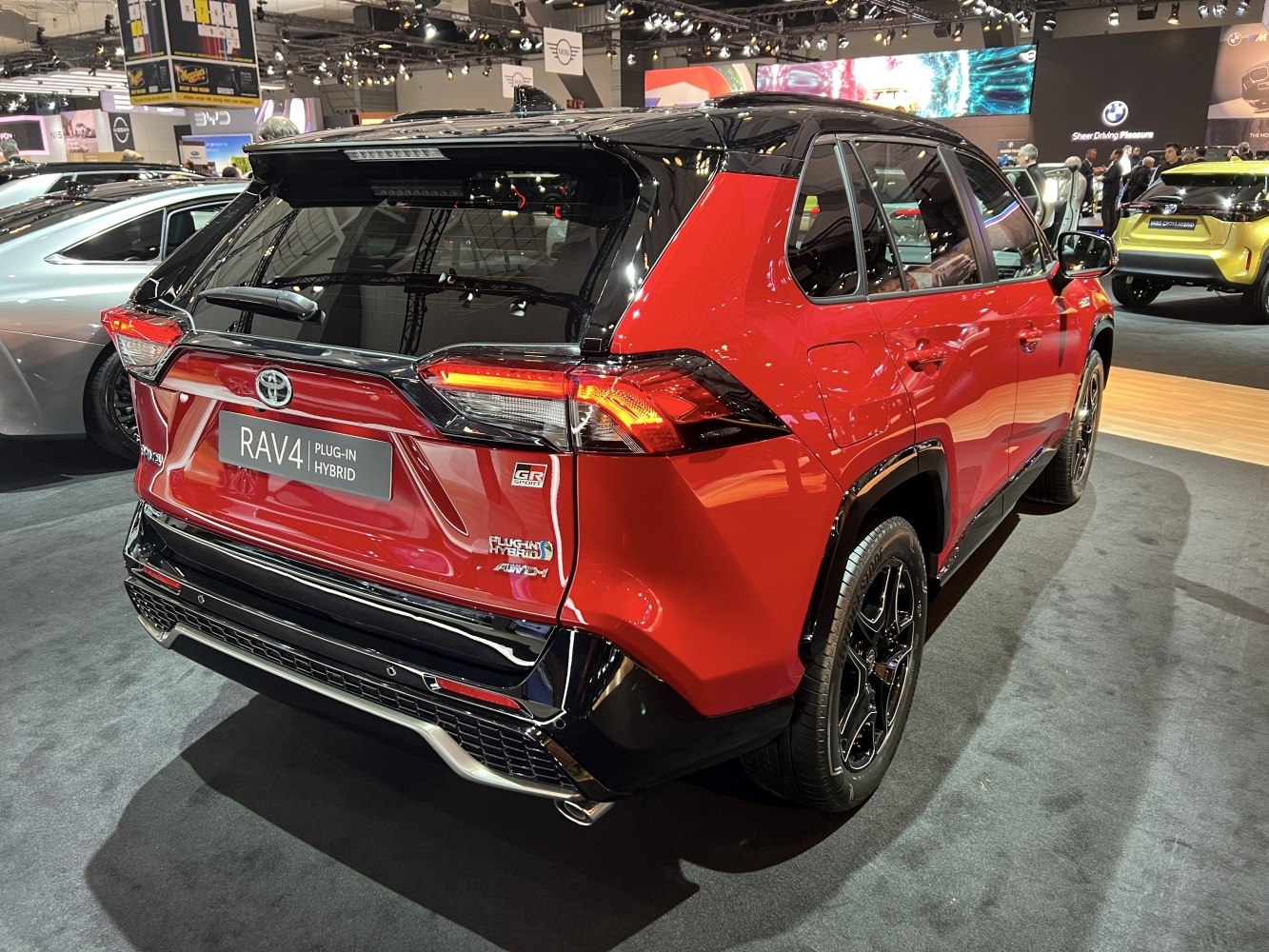 Rear view of a two-tone Toyota SUV with hybrid badges and distinctive LED taillights