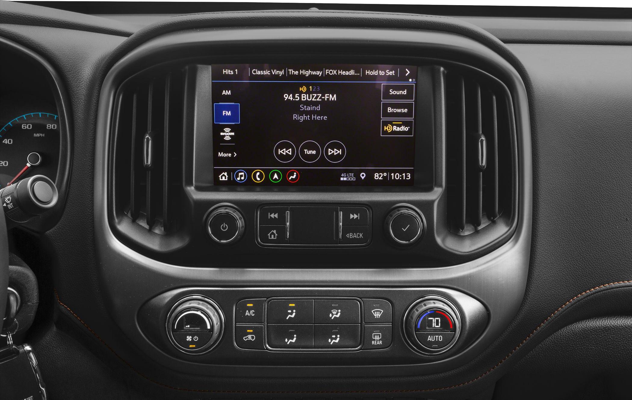 Infotainment touchscreen and climate control panel with digital display and knobs