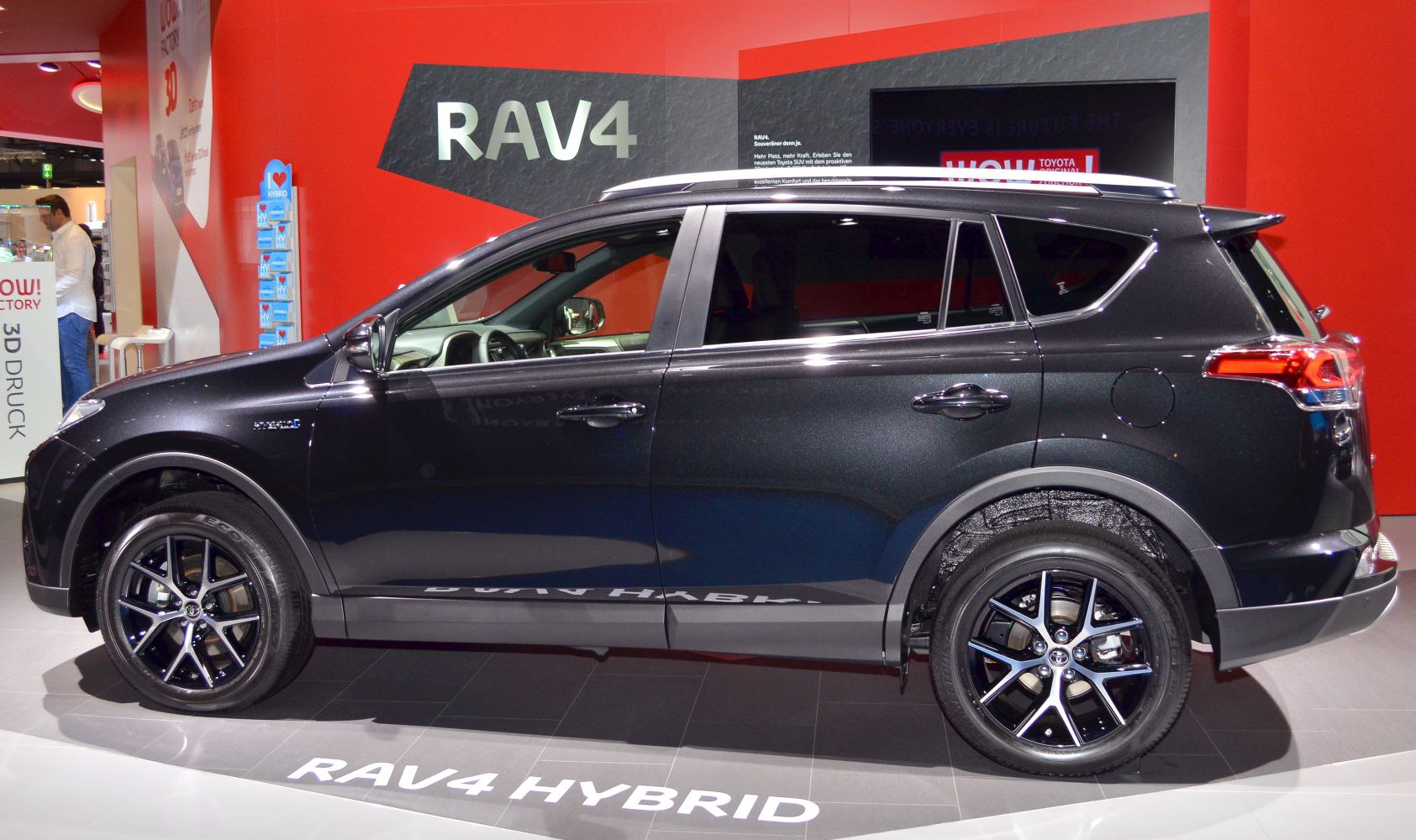 Side profile of hybrid SUV with black alloy wheels and modern SUV design