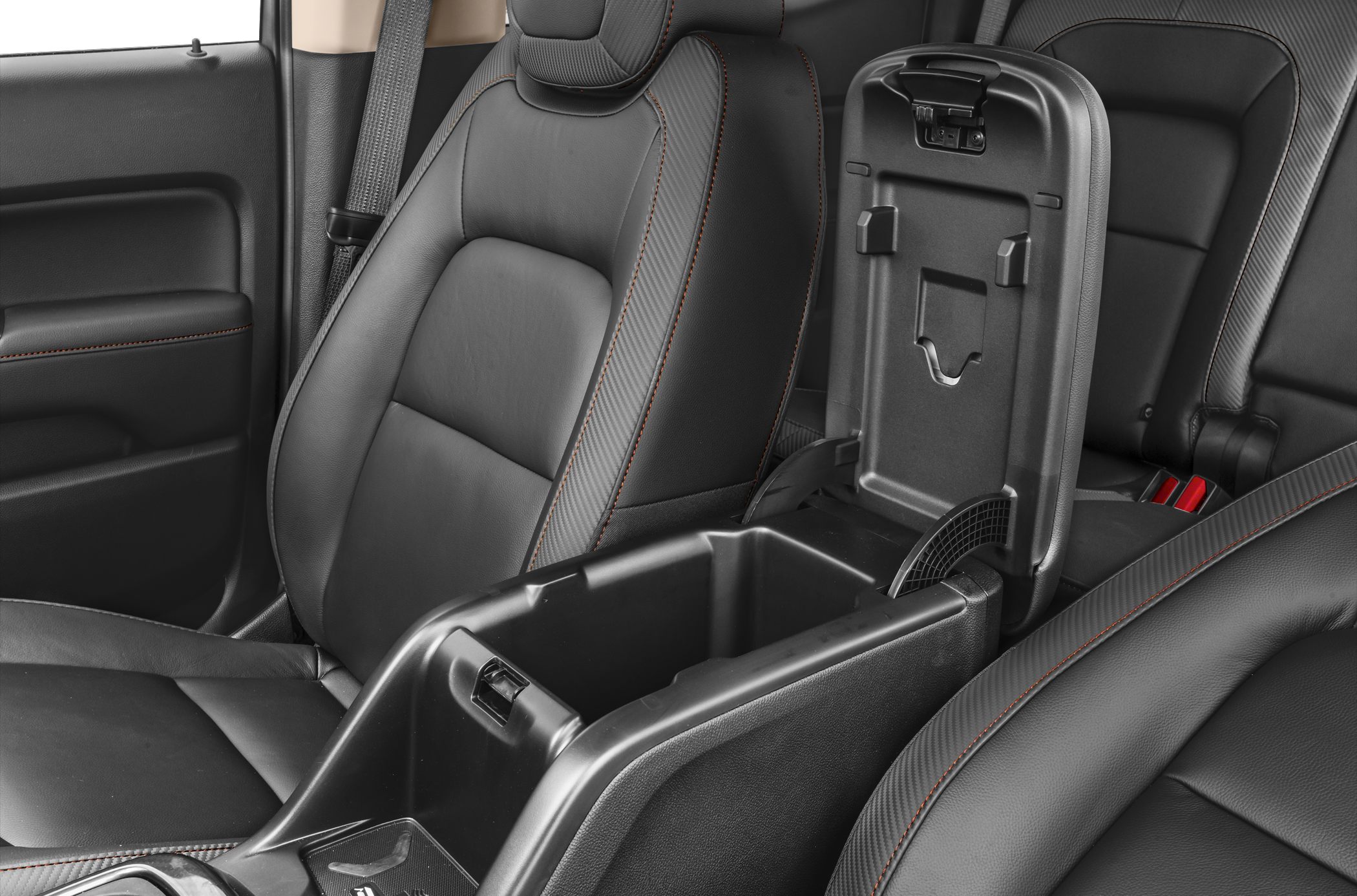 Leather seats with orange stitching and open center storage console.