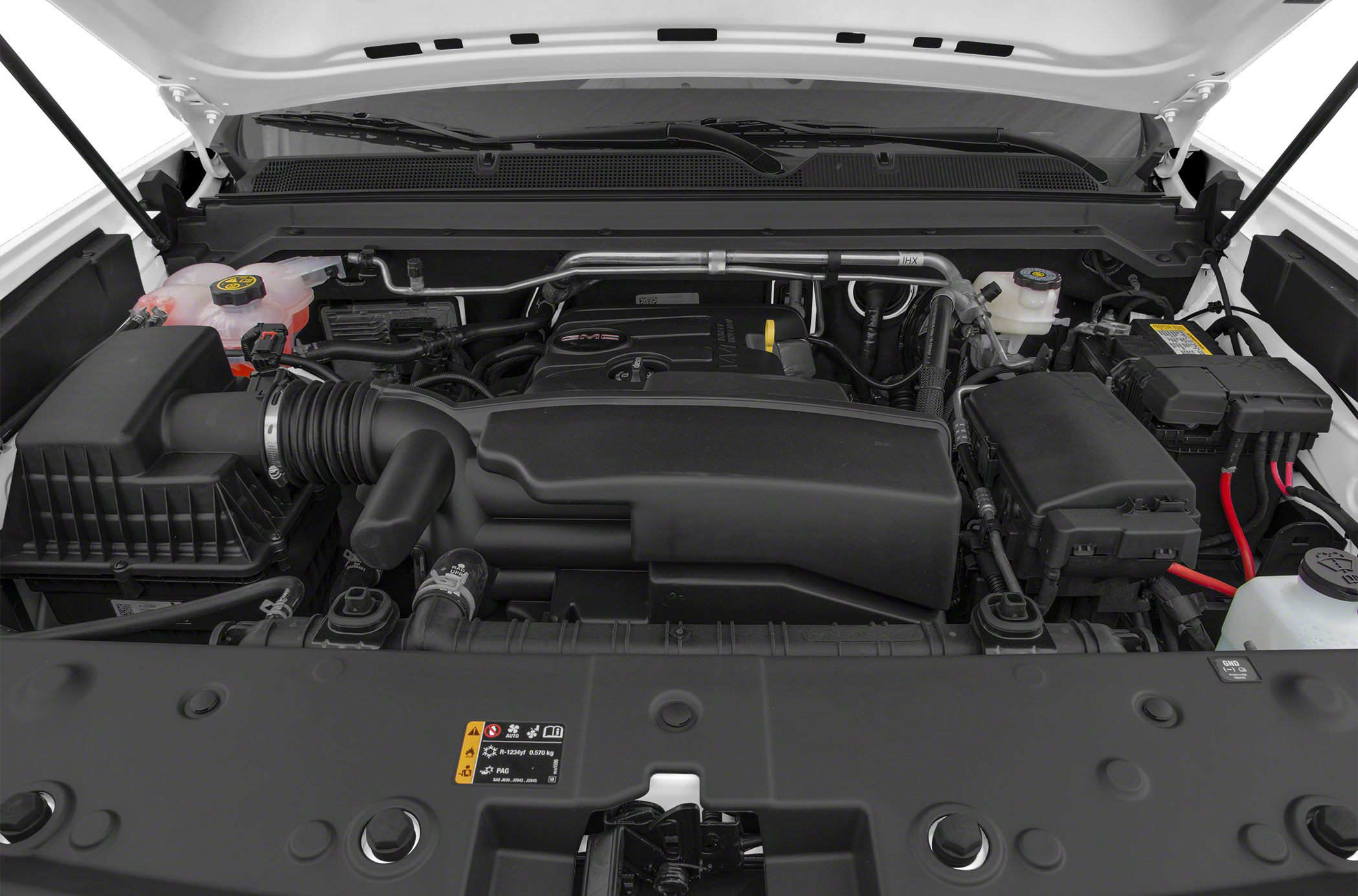 Engine bay with detailed layout of engine components and fluid reservoirs.