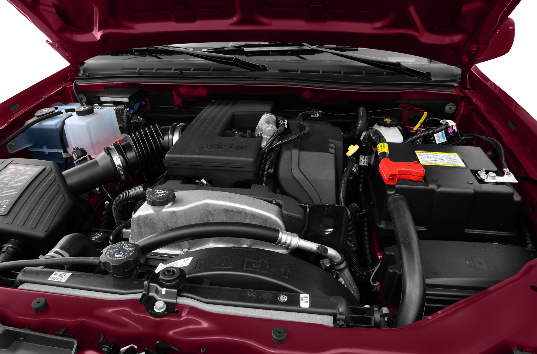 Engine compartment with intake system, cooling system, and battery in open hood.