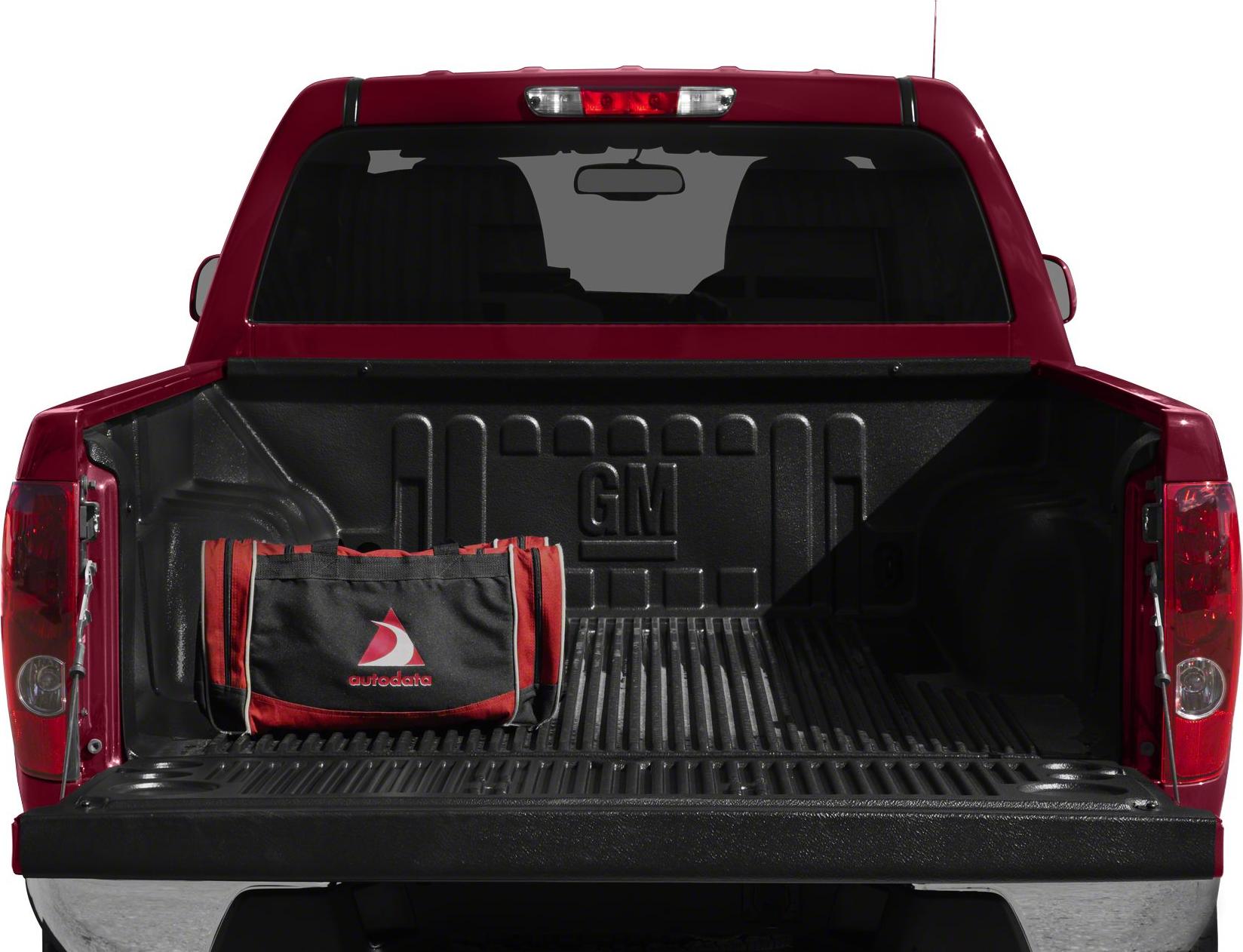 Open truck bed with bed liner and bag inside.