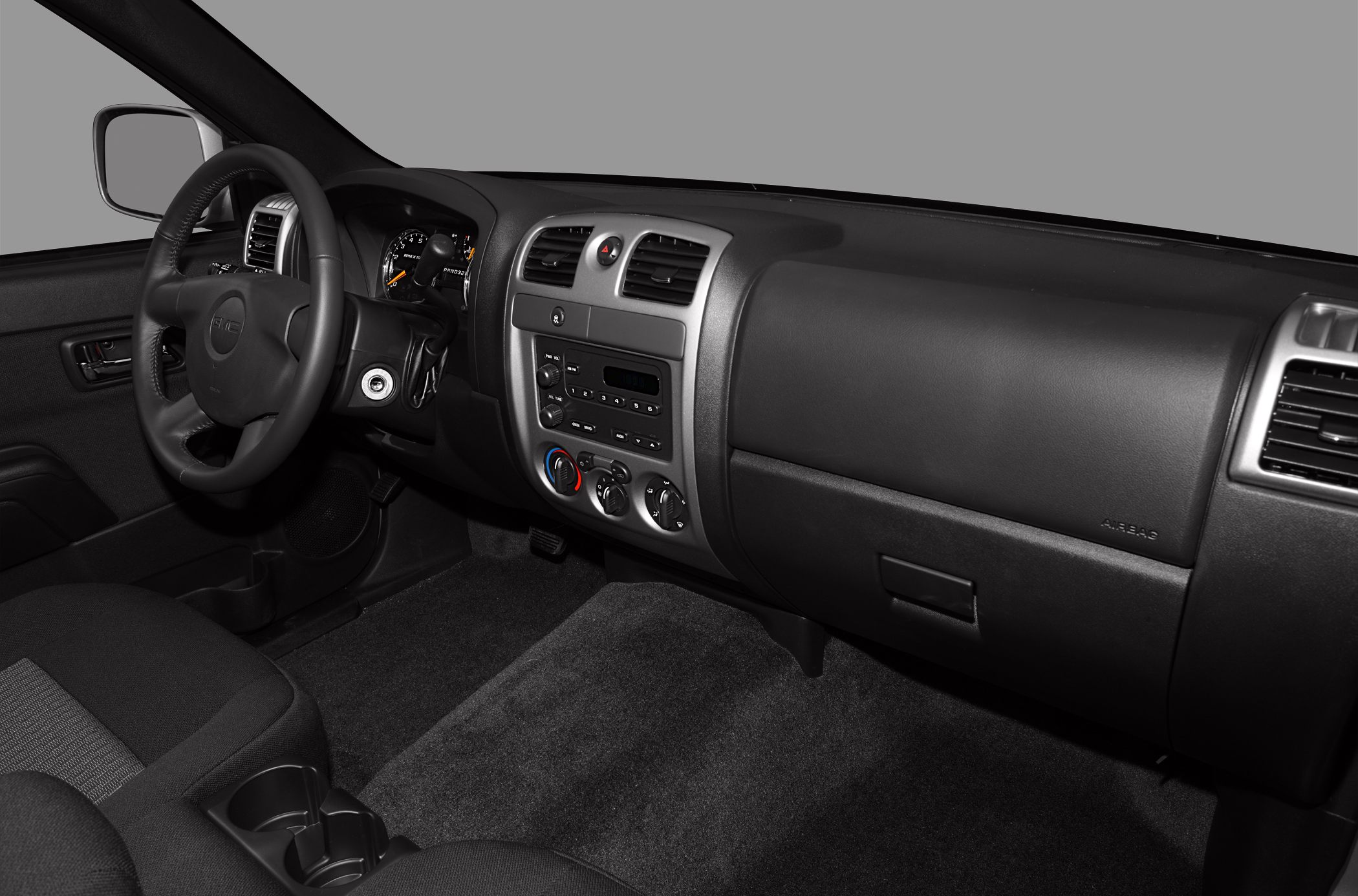 Pickup interior with dashboard, steering wheel, and center console controls