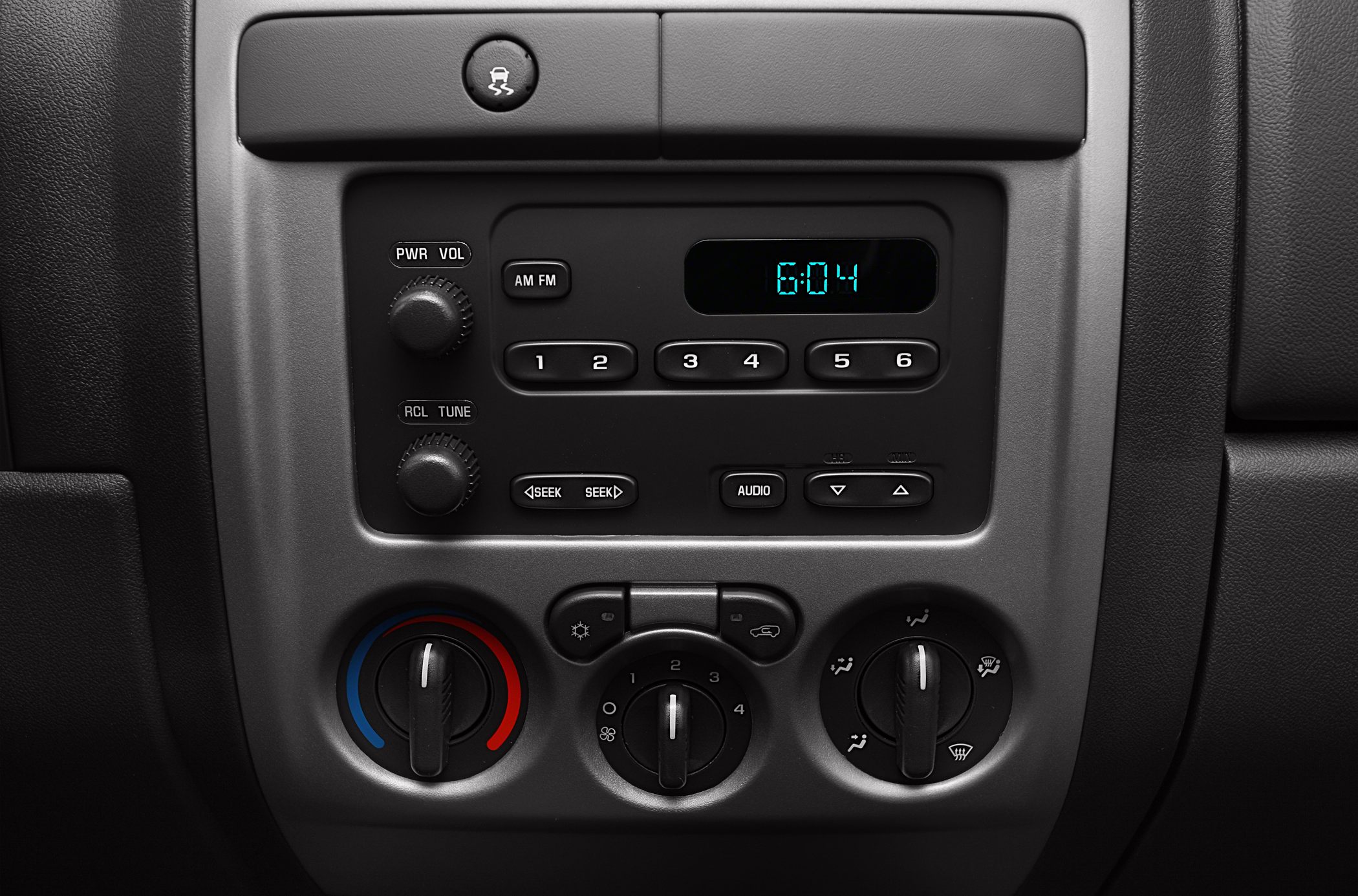 Classic vehicle radio and climate control panel with knobs and digital clock
