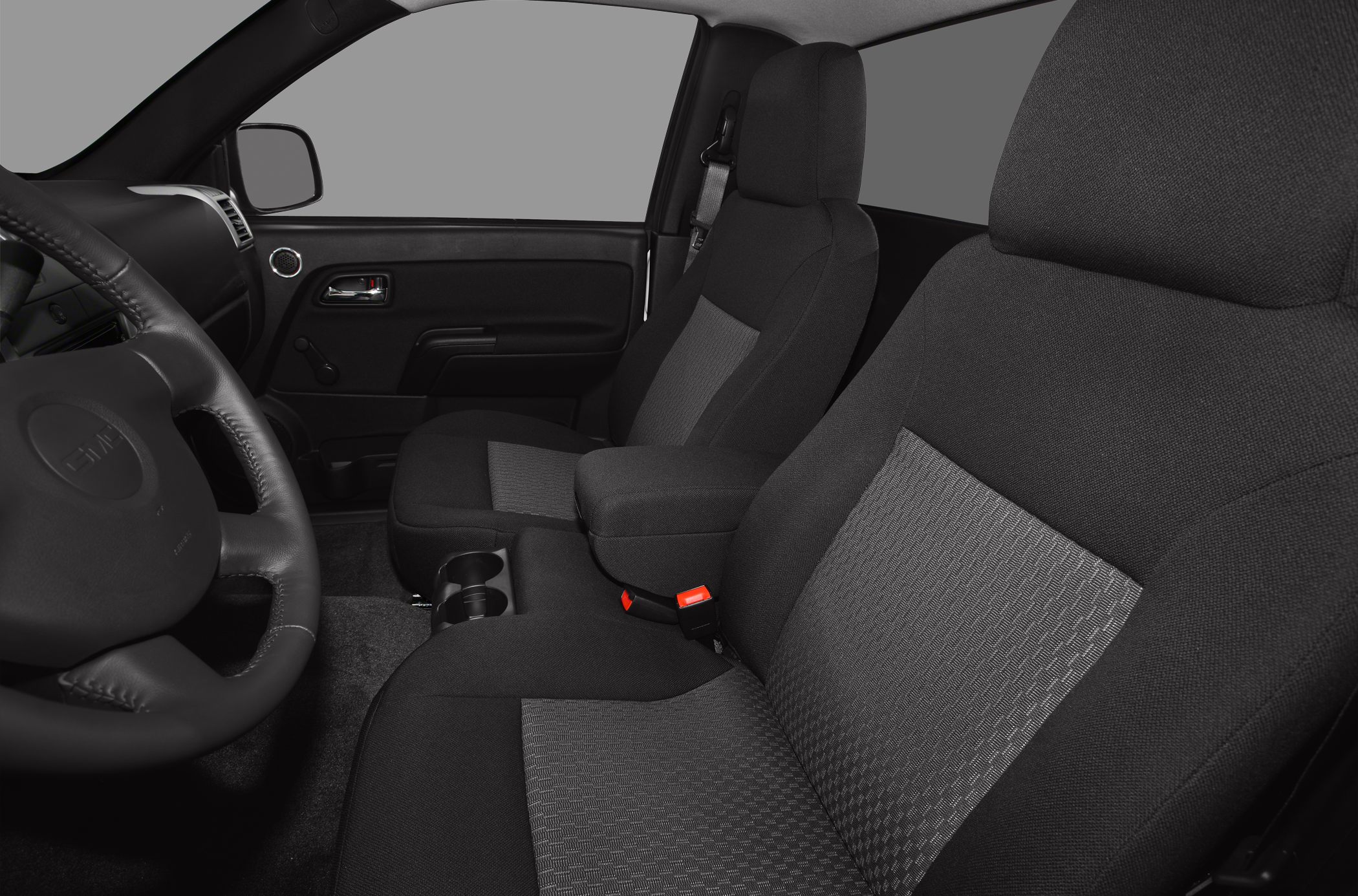 Black fabric bucket seats and central armrest in truck interior