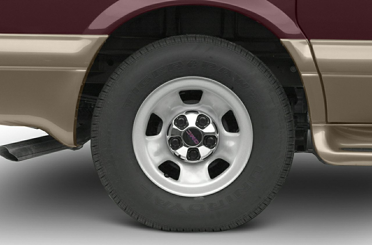 Close-up of rear wheel with Dodge rim and Tiger Paw Uniroyal tire.