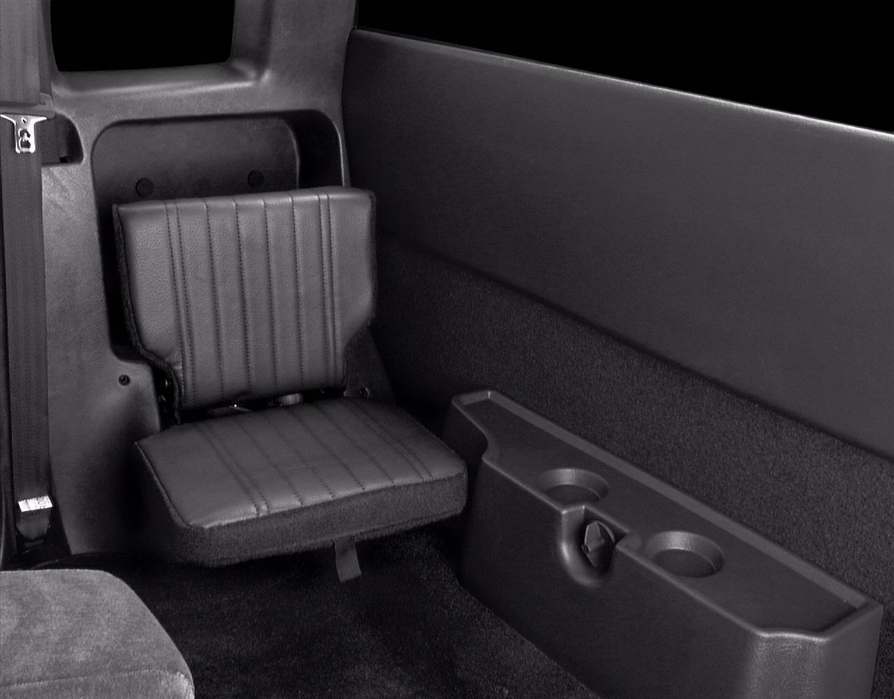 Foldable jump seat and plastic cup holders inside pickup rear interior.