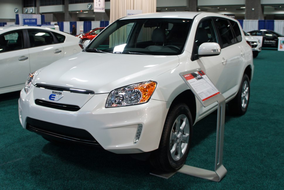 White electric SUV front view with sleek headlights and side mirrors with turn signals