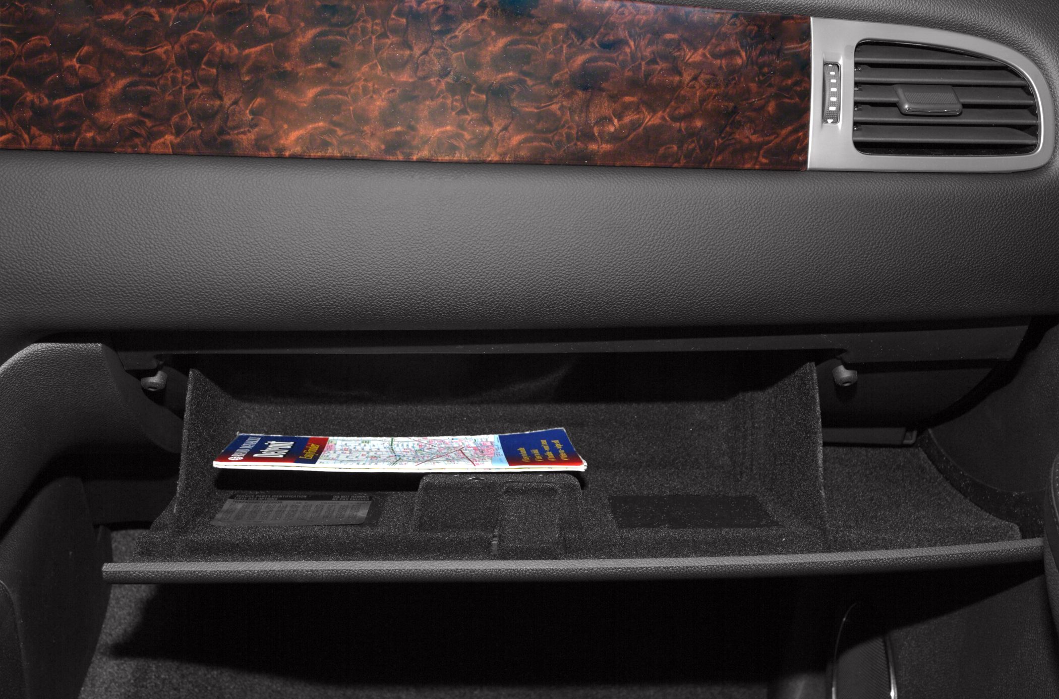 Open glove compartment with wood grain dashboard trim