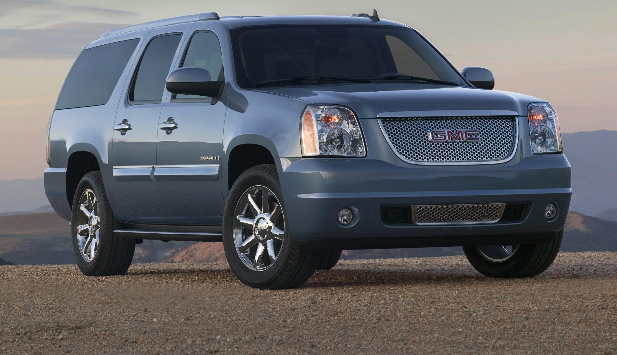 Full-size SUV with mesh grille, chrome wheels, and tinted windows