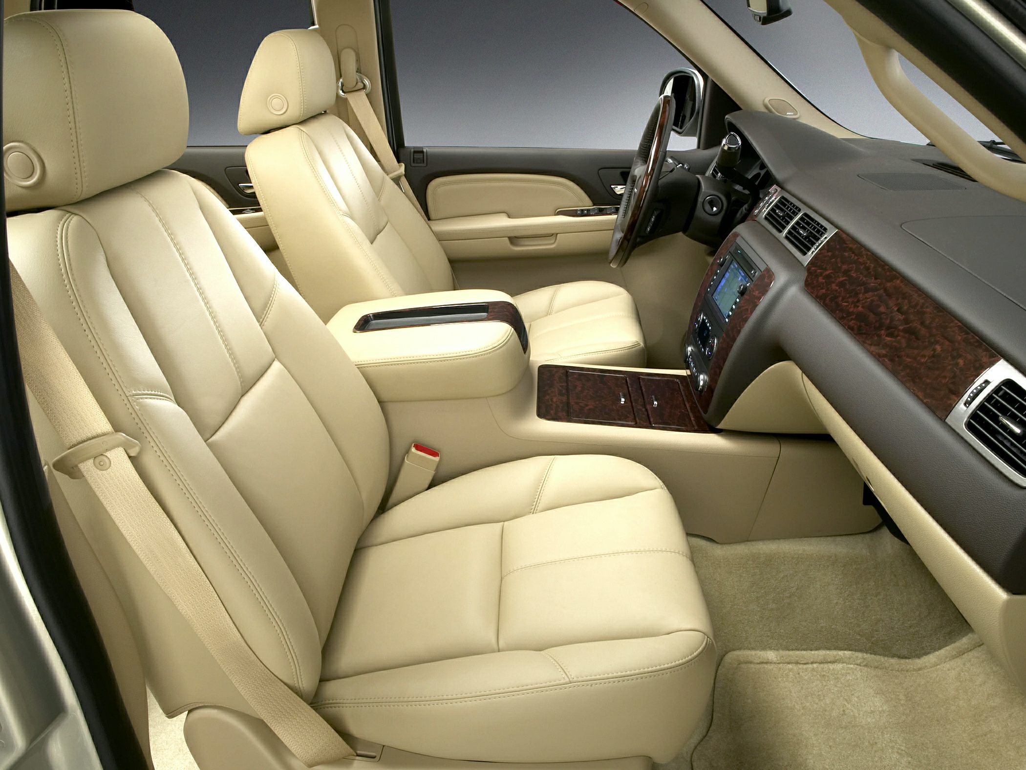 Beige leather front seats with wood trim dashboard and luxurious armrest