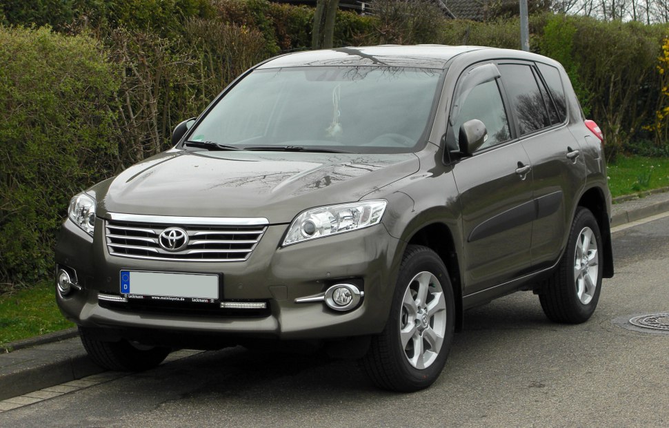 Front-side view of a mid-size SUV with chrome grille and fog lights