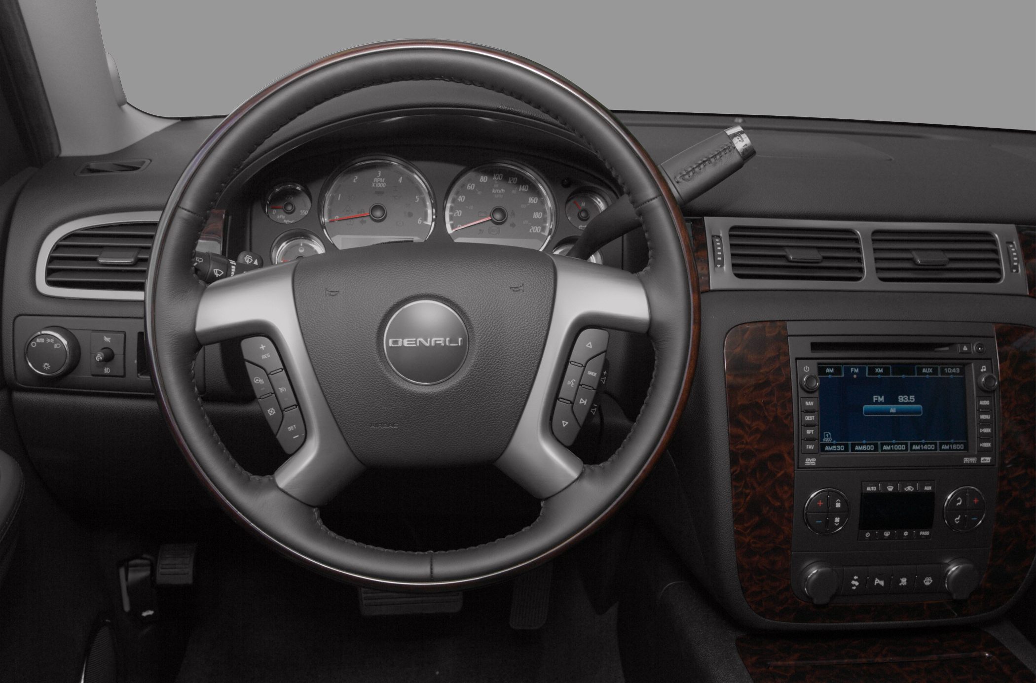 Steering wheel with control buttons and dashboard with infotainment and climate controls
