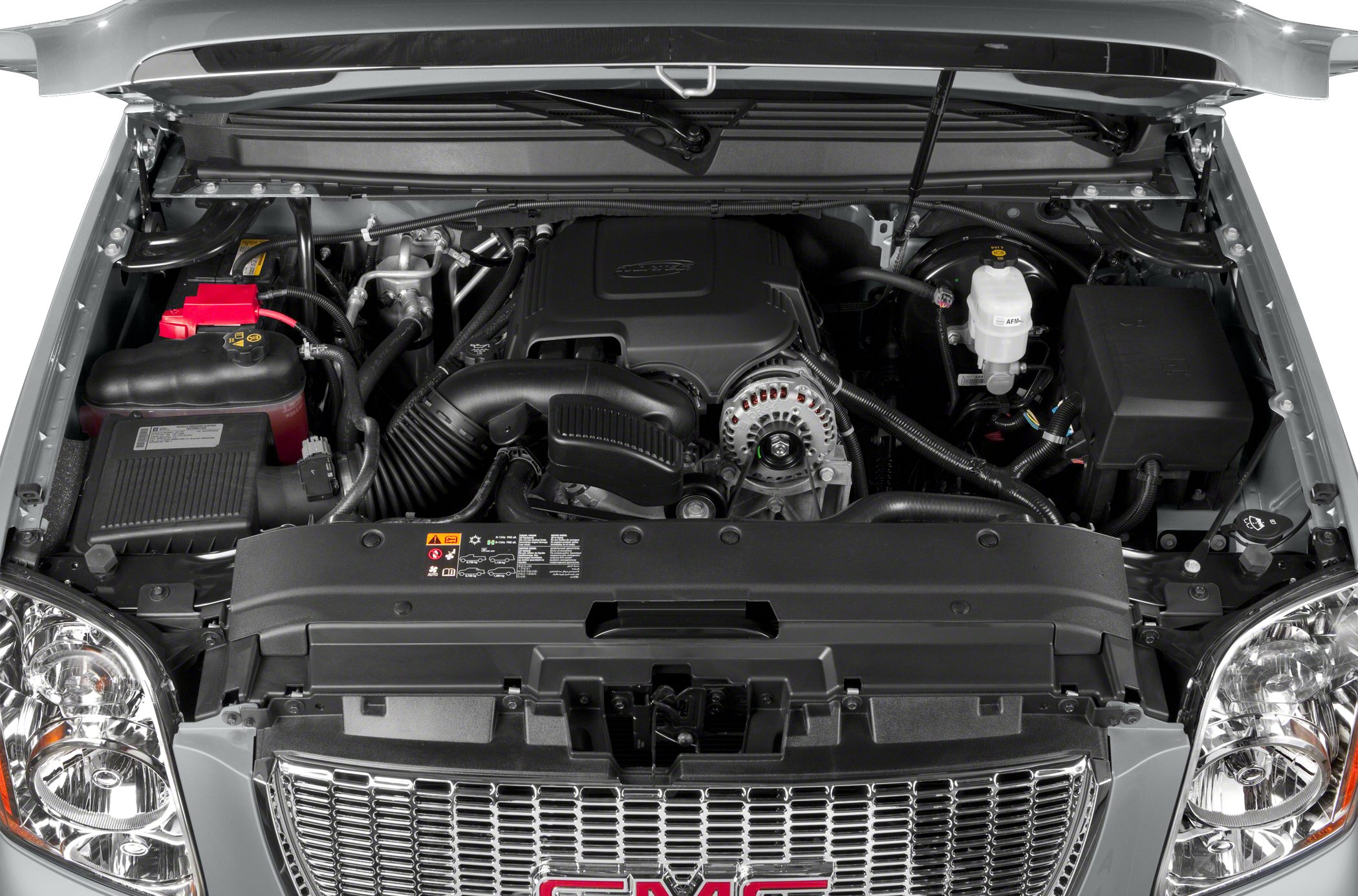 Open engine compartment with detailed view of engine components and front grille