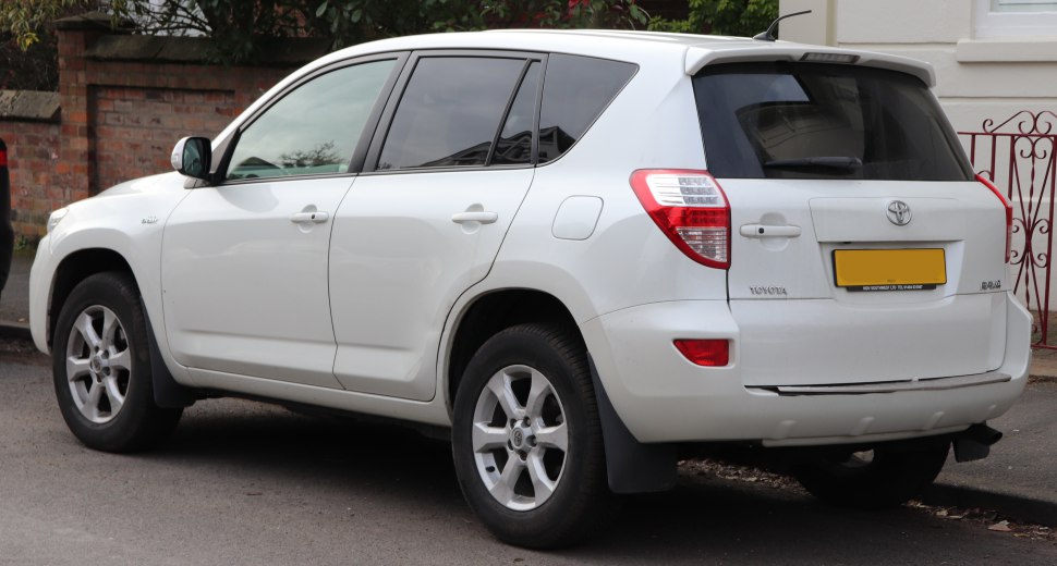 Rear side view of white 2011 SUV with alloy wheels