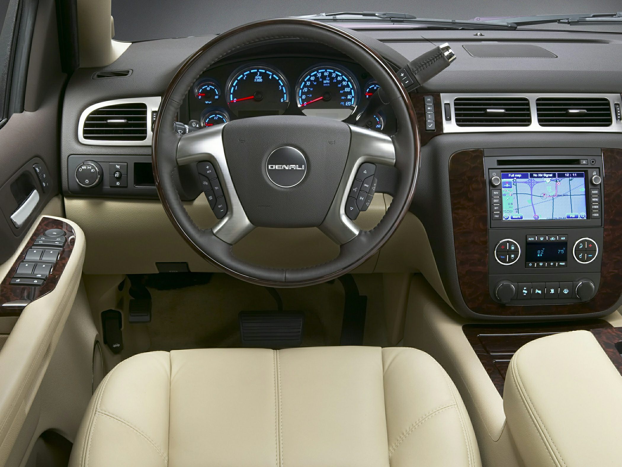 Steering wheel with Denali badge and dashboard with navigation and climate controls.