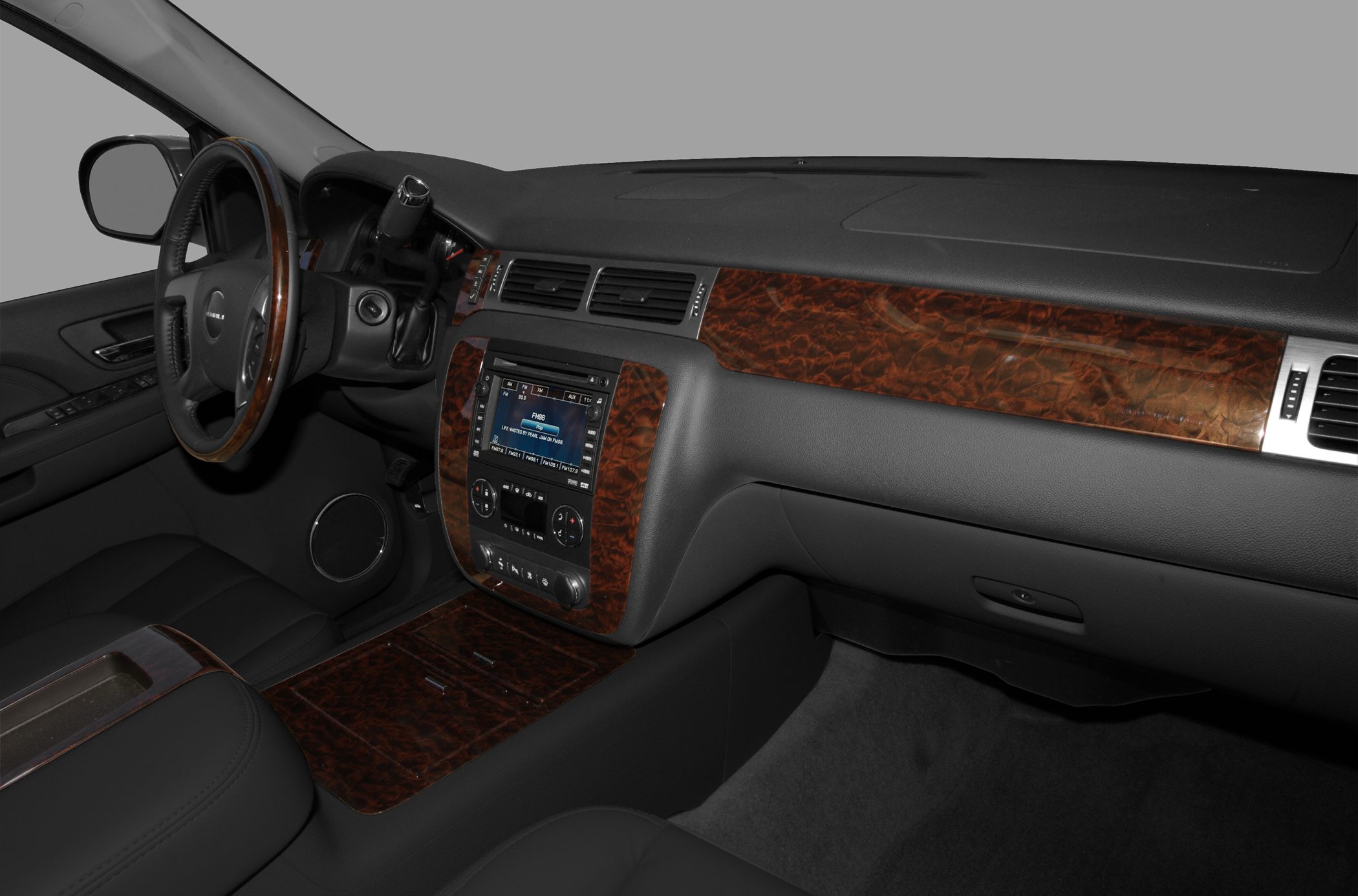 Wood grain trim dashboard and center console with steering wheel detail