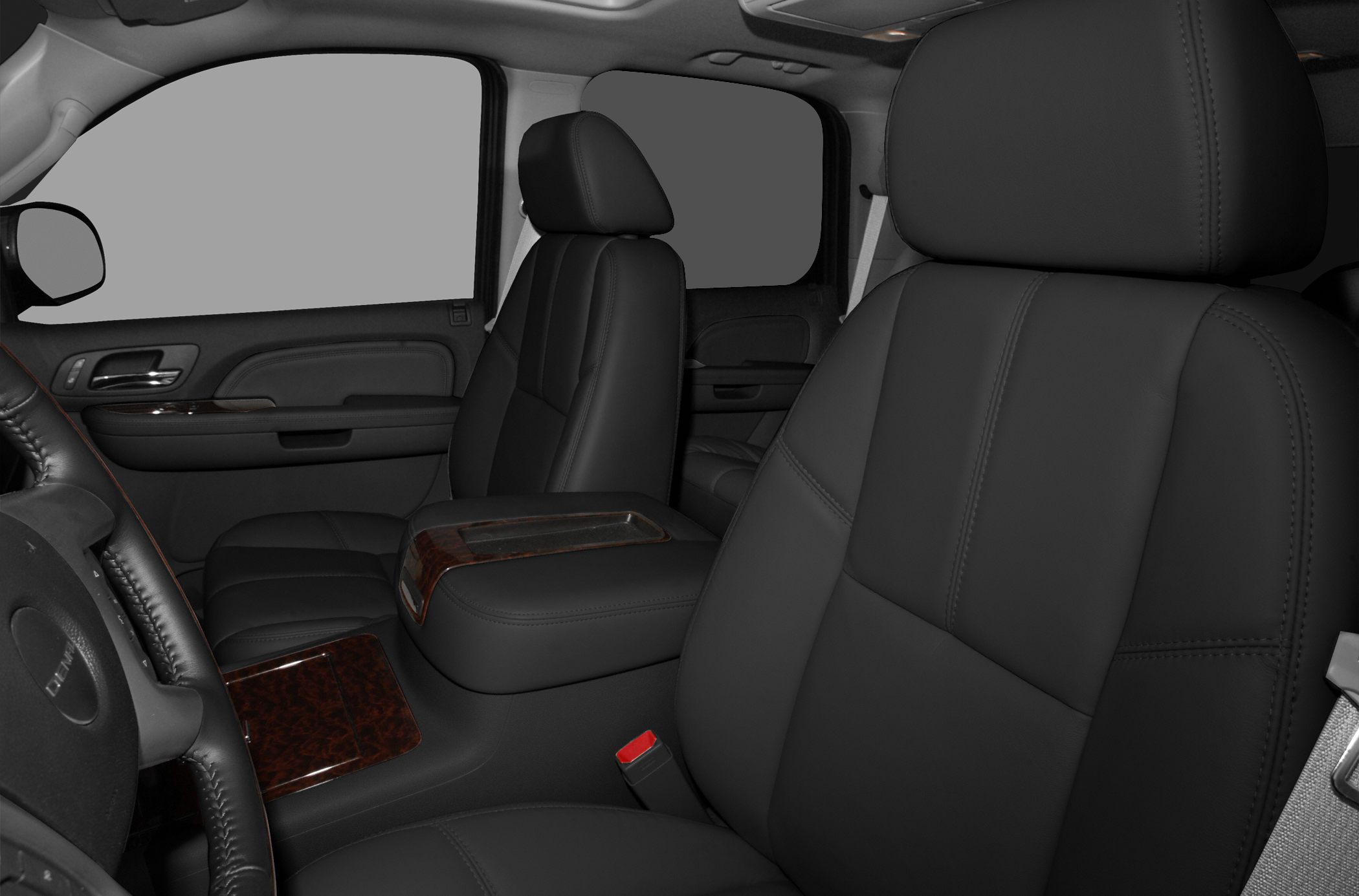 Leather front seats with wood grain dashboard and center console trim.