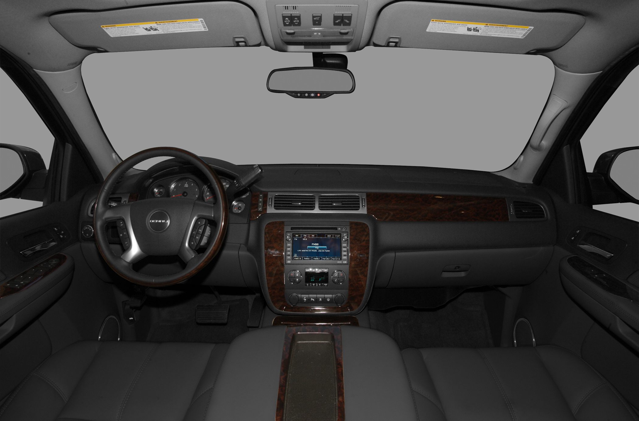 Wood-trimmed steering wheel and dashboard with infotainment system