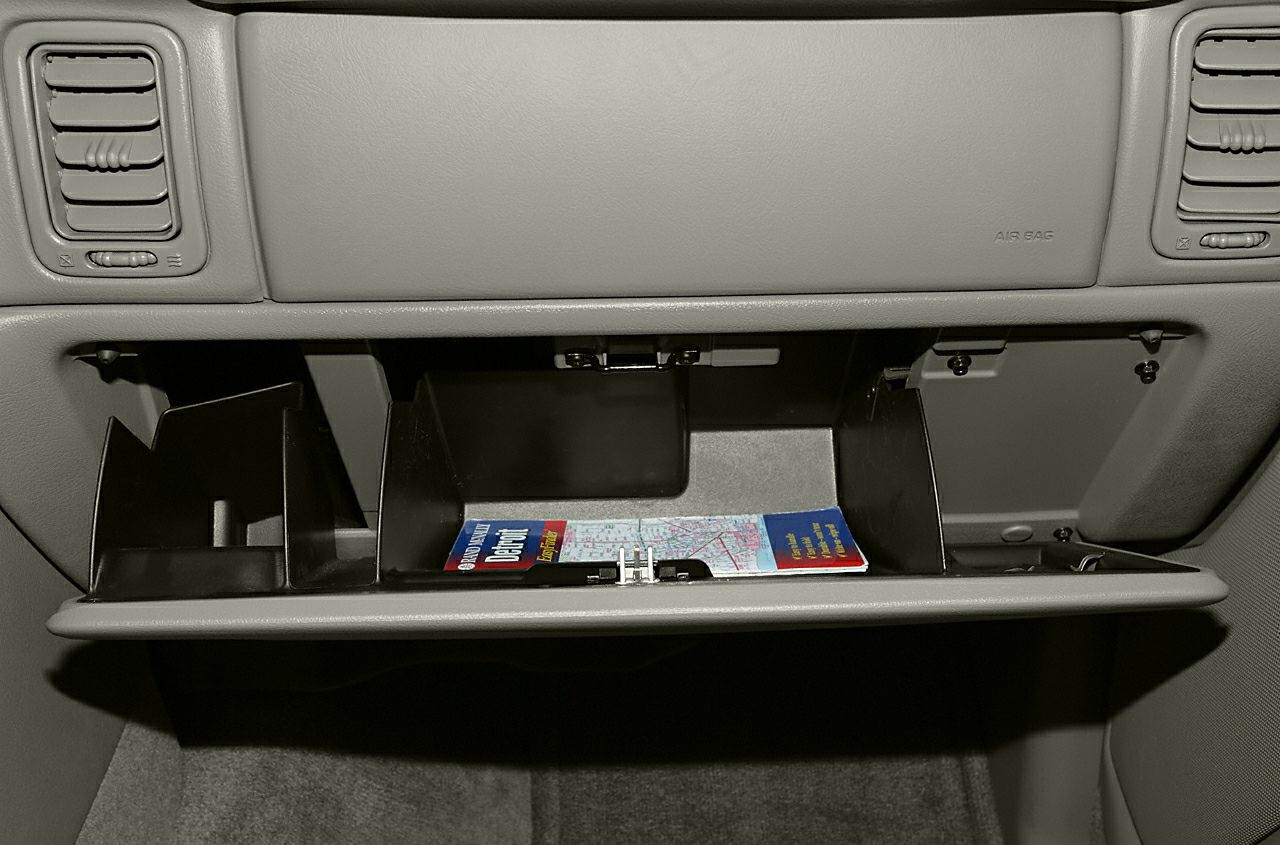 Open glove box with divided compartments and dashboard air vents