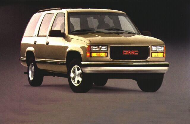 Front angled view of a classic beige SUV with boxy design and 3-door configuration